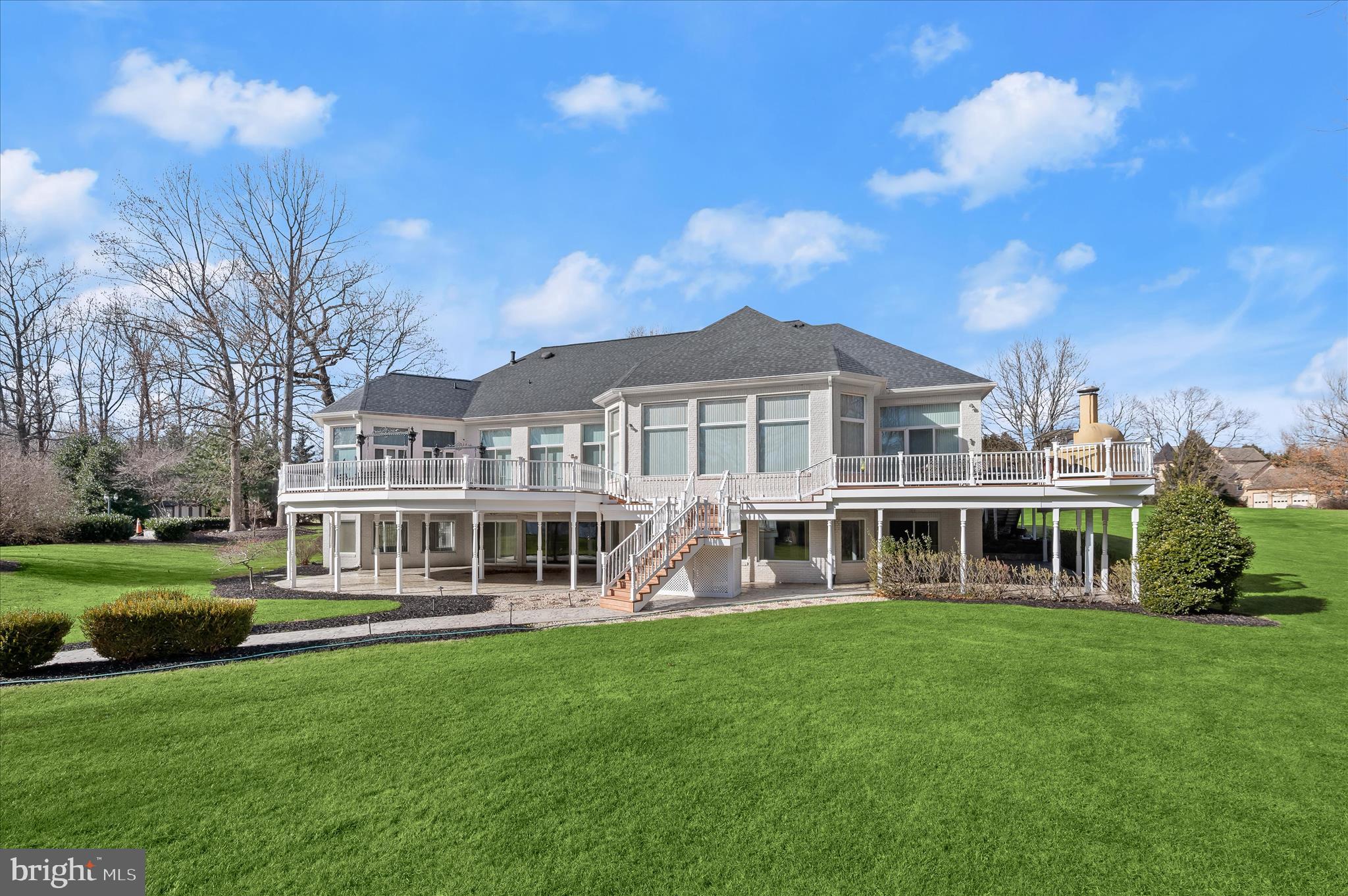 Resort-Caliber Custom Rancher with Architectural Drama, Chef’s Kitchen & Private Pool Oasis 
Custom quality meets resort-style living in this exceptional rancher, thoughtfully designed by a builder and interior designer and set upon a very private, landscaped setting. Built in 2000, this 4-bedroom, 4-bath home offers over-the-top craftsmanship, dramatic architectural details, and seamless indoor-outdoor living.
The main level features soaring 12-foot ceilings, 8-foot solid-core doors, Anderson casement windows, and an extraordinary abundance of natural light through 11 Anderson sliding doors. The heart of the home is the chef’s kitchen—anchored by a striking mushroom-shaped wrap-around island and ceiling cloud with cove lighting—featuring expansive custom cabinetry, dual peninsula bar seating, a divided three-section sink, separate prep sink with filtered and instant hot water, and professional-grade appliances including dual gas Thermador cooktops with griddles, two ovens, warming drawer, dual range hoods with warming bulbs, Sub-Zero refrigerator, Bosch dishwasher, and built-in microwave.
The living room showcases a dramatic ceiling cloud with cove lighting and a central gas fireplace, flowing effortlessly to the dining area and wrap-around TREX deck. The adjacent family/den area opens to the deck through slider doors, creating a perfect entertaining flow.
The main-level primary suite is privately situated in a turret-style space and its own laundry area. Two additional main-level bedrooms include a second en-suite bedroom with new carpet, new private bath, and new built-in wardrobe wall, plus a third bedroom with new carpet. A full main-level laundry room with hook-ups nearby secondary bedrooms adds convenience.  The finished attic level offers a private fourth bedroom with three closets.
The fully finished, full-daylight walk-out lower level is an entertainer’s dream, featuring a recreation room with multiple sliders, the fourth full bathroom for guests, billiards area in the turret, a central wrap-around wet bar/kitchenette, theater room with risers, finished storage room, speakers and multiple ceiling fans.
Outdoor living rivals a luxury retreat with a heated saltwater pool and spa, expansive stamped patios and walkways, outdoor pizza oven, wrap-around deck, water fountain, stone garden walls, vegetable garden with water service, sprinkler irrigation, multiple lamp posts, and professional up-lighting around the home and on evergreen specimen trees. Additional features include a private drive, porte cochere with drive-under access, two added side parking areas, and a 2-car side-loading garage with service door.
Zoned electric heat pump and central A/C, gas hot water, public water, private septic, and over 220 recessed lights throughout complete this one-of-a-kind offering. A rare opportunity to own a truly distinctive home designed for elevated everyday living and unforgettable entertaining.
Please remember to remove shoes and lock up all doors. Thank you for visiting!