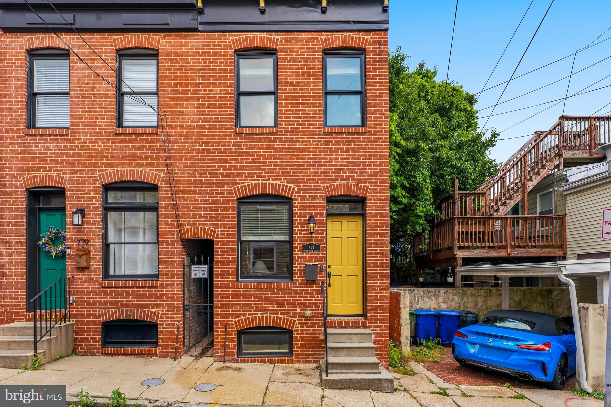 Welcome to 721 South Port Street, a beautifully renovated end-of-group rowhome in the heart of Canton. Featuring two spacious bedrooms, two and a half bathrooms, and remaining CHAP tax credit benefits this home is the perfect blend of historic Baltimore charm and modern convenience.. Step inside to find engineered flooring throughout, exposed brick accent walls, decorative ceiling details, and a neutral color palette. The main level shows off well defined living and dining spaces, a convenient half bath and galley-style kitchen with modern white cabinetry, granite countertops, stainless steel appliances, a deep single sink, and timeless backsplash. Upstairs, the front primary suite features 9-foot ceilings, a tray ceiling with fan, two closets including a walk-in,  and a private bath with dual vanities, a tiled shower surround, and a rain showerhead. The rear bedroom offers its own private full bath, spacious closet, crown molding and ceiling fan, making it perfect for guests, roommates, or a home office setup. Convenient upper-level laundry with a stackable washer and dryer adds to the home's functionality. Outside a spiral staircase leads to the expansive rooftop deck, providing the perfect space to entertain, unwind, and enjoy sweeping city views. Just steps from the neighborhood restaurants, shops, parks, and waterfront attractions this home has a rare combination of city charm with those modern finishes. Set up a showing today!