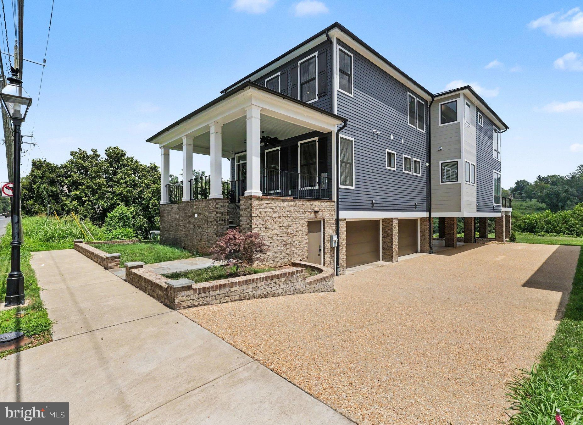 Experience uncompromising luxury in one of Downtown Fredericksburg's most extraordinary riverfront residences. Perfectly positioned along the scenic banks of the Rappahannock River, this exceptional custom home offers the rare combination of timeless craftsmanship, modern luxury, and an unbeatable walkable location just moments from Historic Downtown Fredericksburg's renowned restaurants, boutiques, galleries, and waterfront trails.

Only five years old and impeccably maintained, this residence presents like new while showcasing a level of quality and attention to detail that is seldom found. Rich Brazilian IPE hardwood flooring flows throughout the entire home, complemented by exquisite Craftsman-style trim, extensive custom millwork, elegant coffered ceilings, and thoughtfully designed living spaces filled with natural light and breathtaking river views.

Designed for both everyday living and effortless entertaining, the spectacular gourmet kitchen is truly the heart of the home. Premium quartz countertops, custom cabinetry, a designer backsplash, pot filler, oversized center island, and top-of-the-line Miele appliances create a chef's dream that is as functional as it is beautiful. The open-concept design seamlessly connects the kitchen, dining, and living areas, allowing the stunning waterfront setting to become part of every gathering.

The luxurious primary suite is a private retreat unlike any other, featuring panoramic views of the Rappahannock River and historic Chatham Manor perched majestically on the hillside across the water. Step onto your private balcony to enjoy peaceful mornings, or retreat to the spa-inspired ensuite complete with heated floors, dual quartz vanities, an oversized walk-in shower, an expansive walk-in closet, and a convenient beverage center—creating a true five-star experience.

Luxury extends throughout every level with heated bathroom floors, premium finishes, generous bedroom suites, elevator access for effortless convenience, and exceptional attention to detail in every space.

Outdoor living is equally impressive. Enjoy spectacular sunrises over the Rappahannock from the expansive rear deck while taking in unobstructed waterfront views that stretch across to historic Chatham Manor, one of the region's most iconic landmarks. The adjacent open green space provides an added sense of privacy rarely found in downtown living.

Car enthusiasts and guests alike will appreciate the incredible parking accommodations, including a secure four-car garage, two additional covered parking spaces, and a private paver driveway—an exceptional amenity in the heart of the city.

This is more than a home—it's a lifestyle defined by luxury, convenience, and unforgettable waterfront living. Opportunities to own a nearly new, custom-built riverfront residence with this level of craftsmanship, premium finishes, expansive parking, elevator access, and walkability to Historic Downtown Fredericksburg are exceedingly rare. Discover one of the city's finest luxury offerings and experience waterfront living at its absolute best.