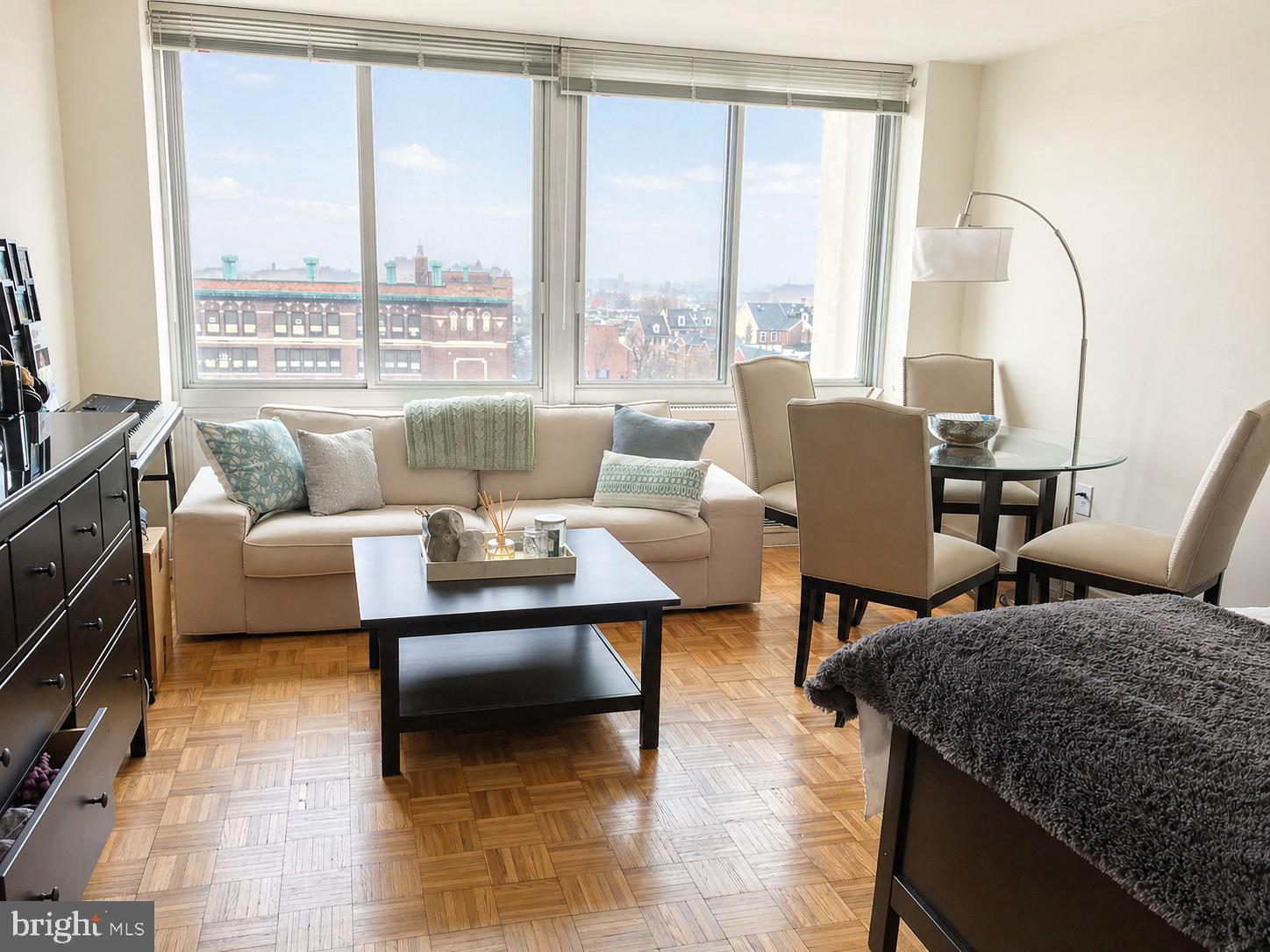 Light-filled studio with southern city views at Hopkinson House on Washington Square.  Enter through a foyer with large coat closet into the open great room boasting great natural light from oversized windows and ample space for various furniture layouts. Adjacent is the fully equipped kitchen with ample wood cabinetry and tile backsplash. There is a separate dressing area with excellent closet space that leads to the full bathroom featuring a tub shower and white tilework throughout. Additionally this home enjoys parquet wood floors and excellent storage space throughout. Residents of Hopkinson House enjoy a 24-hour doorman and on-site management. There is a seasonal rooftop pool with see-forever city views and valet parking in the building for an additional fee, subject to availability. Hopkinson House is in close proximity to many of the city's historic and cultural sites, some of the city's best shopping and dining and provides easy access to the Broad Street and Market Street office corridors, as well as 676, 95, Amtrak's 30th Street Station and the Philadelphia International Airport.