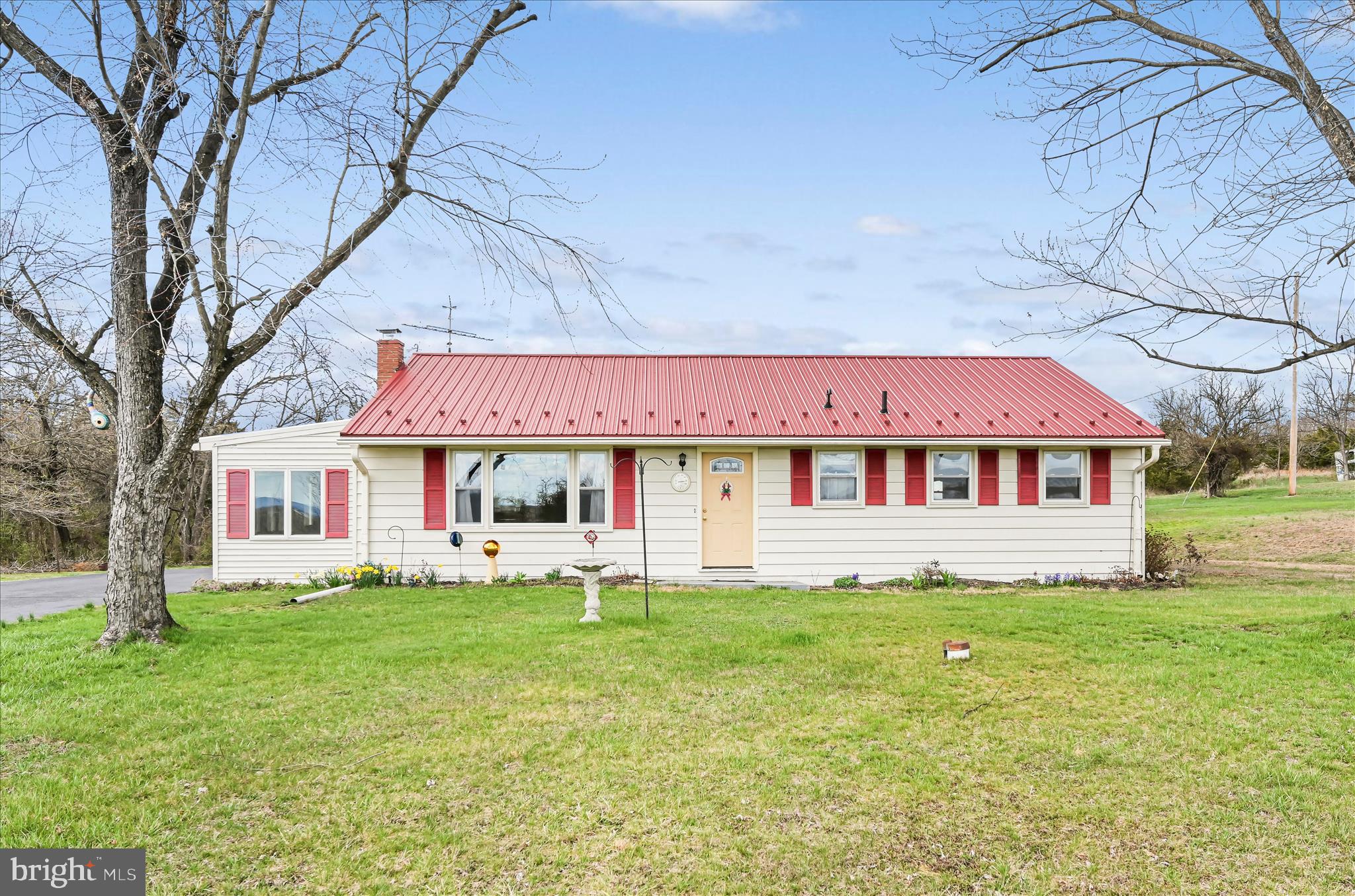 The previous buyer's loss due to financing is your win! This solid ranch home just appraised for more than $255k and is in a peaceful country setting is ready for your vision. On just over an acre, it features a large living room with replacement windows, hardwood floors under the carpet, & accessible bathroom. Enjoy the bright 3-seasons room & expanded driveway with ample parking. The metal roof is newer. Storage is abundant with a waterproofed basement & pull-down attic. The move is on!
