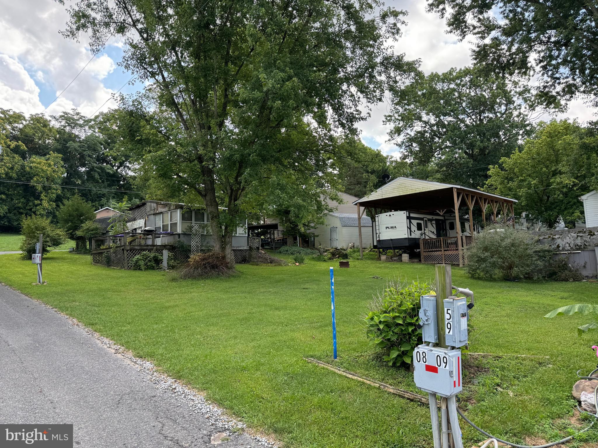 Priced to sell! TWO LOTS only 1 block from the river. Each lot has its own separate water and electric hookups. One lot includes a small camper with two beds, kitchenette, and half bath. Large porch attached for extra living space and shed for storage. Use the second lot for an additional camper and still have plenty of room for parking vehicles and boats. Seasonal campground, gated community, open from April 1 to November 1 with river access and amenities, 3 amazing swimming pools, restaurant, chapel, horseshoe pits, mini golf, playgrounds, basketball and tennis courts. Very active community with many events including bingo, flea markets, car shows, festivals, and so much more. Come enjoy your summer at this relaxing gem.