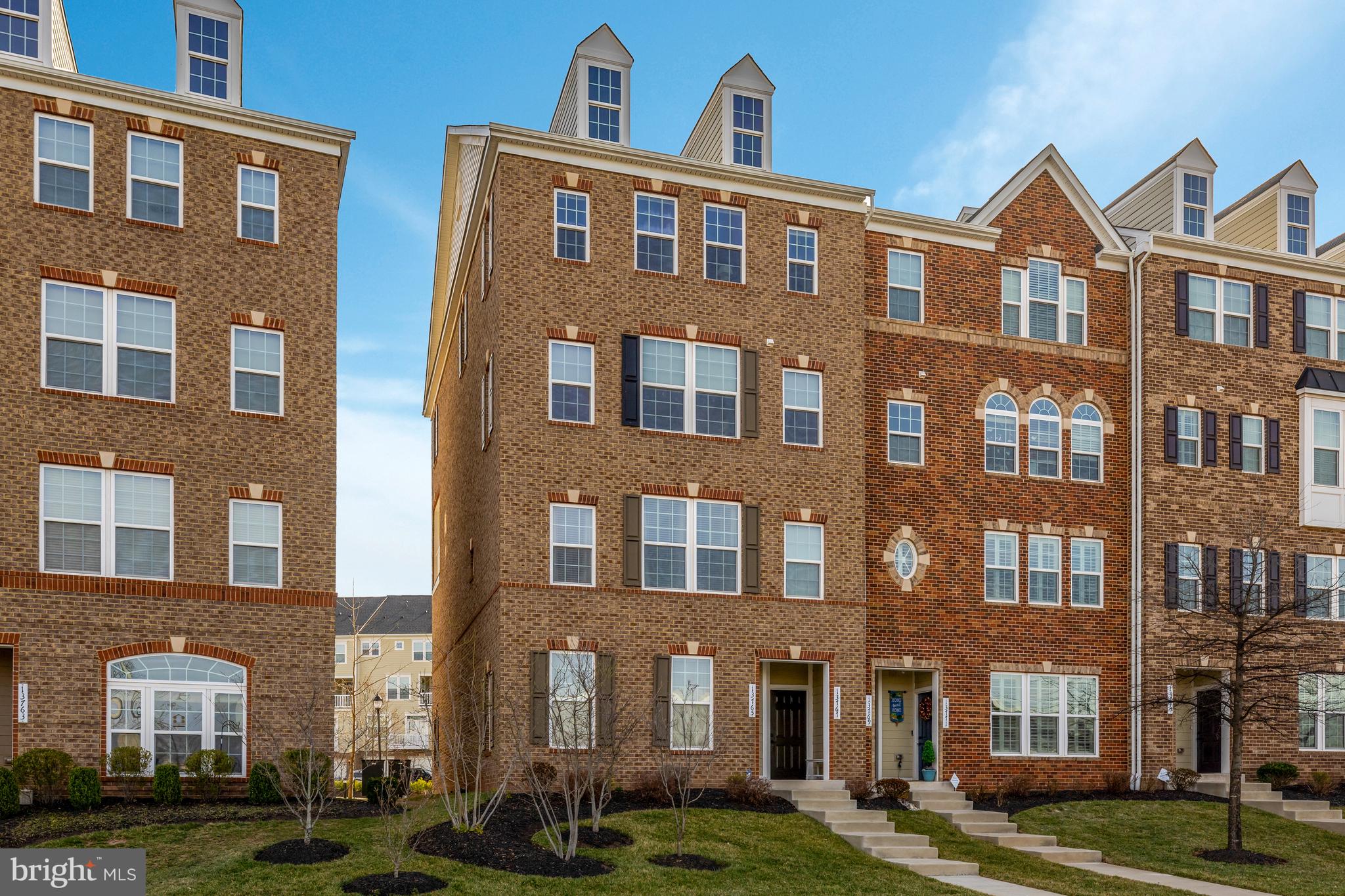 Own this exceptional upper end-unit condo featuring 3 bedrooms and 2.5 baths, with a builder's estimate of 2,611 total square feet—2,516 of which are on the upper two levels. This home includes a one-car garage and driveway parking for an additional vehicle.

The condo showcases stylish designer upgrades, such as high-end hardwood flooring, cabinetry, granite countertops, and upgraded bathroom tile and fixtures. As a corner unit, it is filled with natural light from additional windows, creating a bright and airy atmosphere throughout. Enjoy stunning sunsets from the comfort of your home.

The luxury condo features a spacious open floor plan with hardwood floors and an upgraded kitchen equipped with stainless steel GE appliances, granite countertops, and a stylish backsplash. Highlights include a primary suite with dual walk-in closets and a convenient laundry area with a washer and dryer located on the upper level.

Step outside to a private balcony off the family room, a spacious front yard, and additional storage space in the garage. The home also boasts modern finishes, including 9-foot ceilings, gas heat, and gas cooking. It is conveniently located within walking distance to parks and just minutes from the Air and Space Museum, Dulles Airport, major highways, and top-rated schools. Nearby shopping, restaurants, and entertainment options, as well as easy access to the Silver Line Metro, make this condo a prime choice for comfort and convenience.

The condo fee covers water, sewer, trash removal, snow removal, common area maintenance, lawn maintenance, road maintenance, playground access, jogging and walking paths, volleyball courts, common grounds, picnic areas, and a clubhouse. In today’s market, it is rare to find a condo fee this low with so many amenities included, even covering water bills. Additionally, there is plenty of guest parking available in the rear of the building.