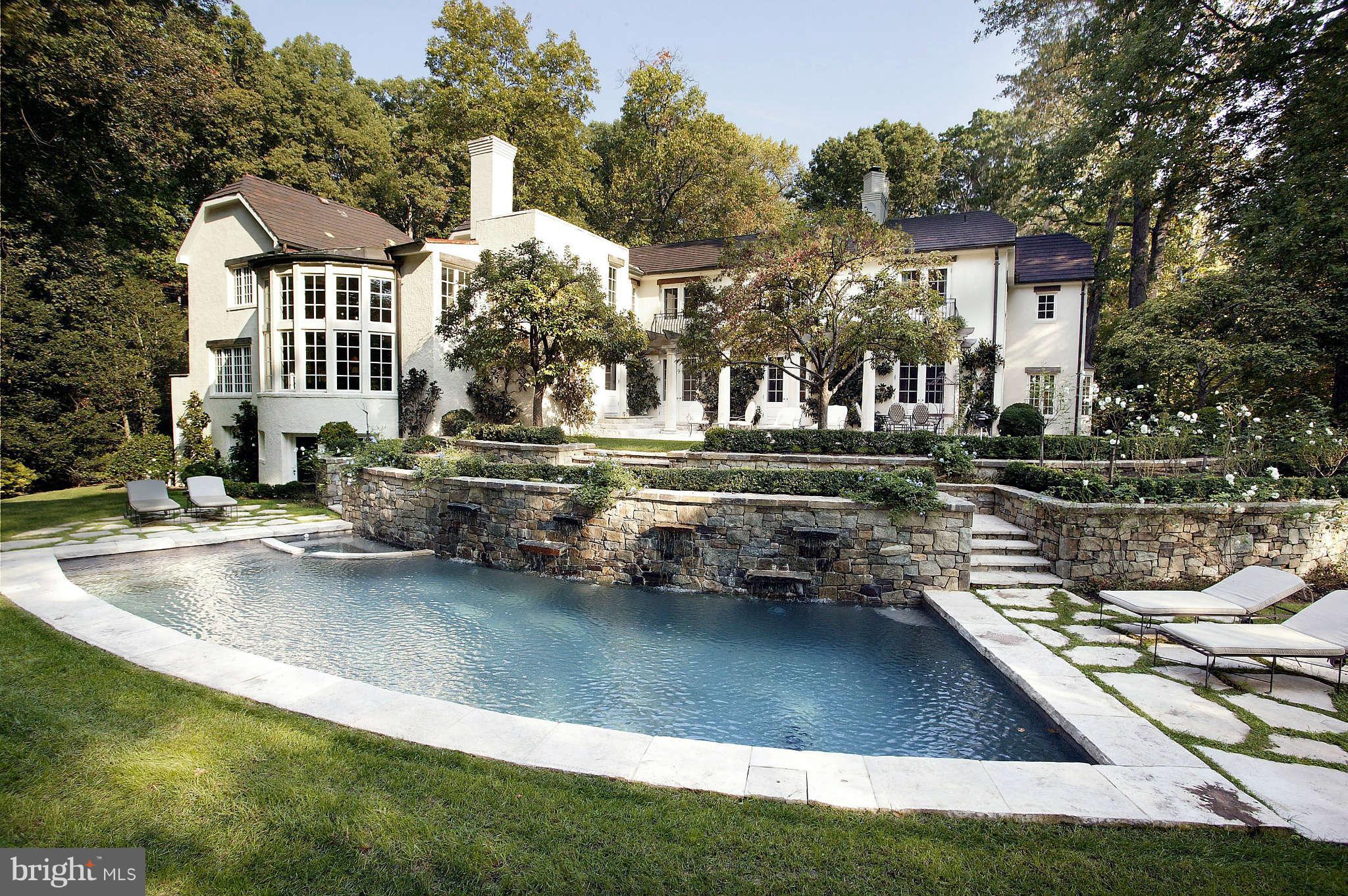 Located in prestigious Ballantrae Farms, this exceptional home is sited on 1.89 private & exquisitely landscaped acres.  Bath in sun-light this rare offering offers circular cobblestone driveway, custom finished floors & walls, 2-story family room overlooking property & pool w/ waterfall,  3-car gar, wine cellar, maid's quarters & room for a tennis court. Featured in Southern Accents Magazine.
