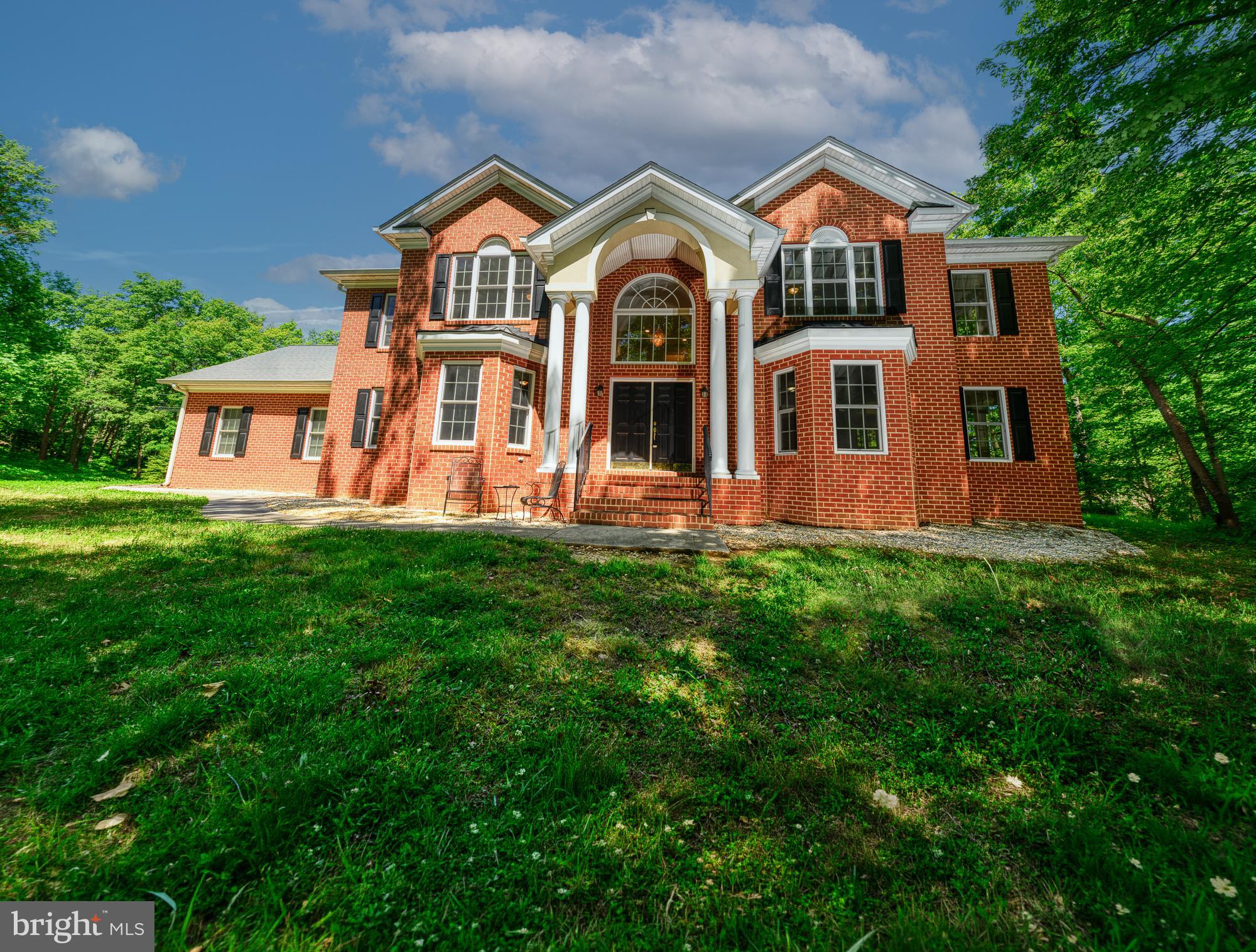 Welcome to 4431 Trail of Faith Court—a beautifully updated residence offering space, privacy, and timeless design on 5.75 private acres. This impressive home combines classic curb appeal with modern interior updates, creating a property that is both functional and inviting.
From the moment you arrive, the brick front exterior with stately columns sets the tone for what awaits inside. Enter through the grand two-story foyer, highlighted by a stunning crystal chandelier and an abundance of natural light that flows throughout the home.
Offering 5 bedrooms, 3 full bathrooms, and 1 half bathroom, this home provides a versatile floor plan designed for both everyday living and entertaining. The main level features a private library/home office with built-in bookshelves, ideal for working from home, studying, or creating a quiet retreat.
The updated kitchen serves as the heart of the home and features new cabinetry, granite countertops, newer stainless-steel appliances, and new flooring, blending style and functionality for cooking, gathering, and entertaining.
Additional living spaces include a bright sunroom, offering peaceful views of the surrounding property and creating the perfect space to relax year-round.
Upstairs, Bedrooms 3 and 4 are connected by a spacious Jack-and-Jill bathroom complete with a separate linen closet, providing both convenience and privacy.  The primary bathroom includes a separate shower/steamer that your clients will enjoy after a long day in the office or after a work out to help relax.
Recent improvements include fresh interior paint throughout, enhancing the home’s move-in-ready appeal.
Situated on private well and septic, this property offers the benefits of country living while still being convenient to area amenities. The expansive acreage provides endless possibilities for outdoor recreation, gardening, entertaining, or simply enjoying the peace and privacy of your own retreat.
This is a rare opportunity to own a thoughtfully updated home with acreage, privacy, and space to grow.
Schedule your showing today.