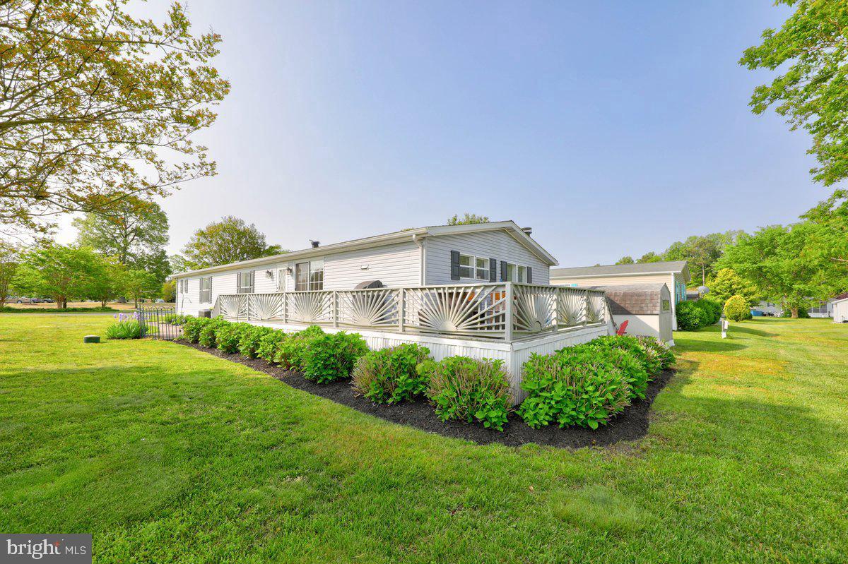 This thoughtfully updated home in Angola Estates shows beautifully! It offers an expansive yet comfortable layout that works just as well for everyday living as it does for gathering with friends and family.  TWO dining areas (three if you include the massive island), TWO living areas! The open-concept kitchen, family room, and casual dining area create an easygoing space where everyone can be together. The kitchen has been refreshed with refinished cabinetry, granite countertops added in recent years, updated appliances (approximately 2021–2022), an oversized center island with an overhang for seating, and generous pantry storage. The large table space features a patio door  leading to the deck, while the nearby laundry room includes a convenient half bath with an updated vanity.  The adjoining family room is filled with natural light and a corner fireplace adds a cozy touch. 

Toward the center of the home, a separate living room and dining room, both with refreshed carpeting, offer additional space for hosting holidays, movie nights, or simply enjoying a quieter section of the house.

Down the hall, the bedroom wing includes two comfortable guest rooms and a full bathroom with an updated vanity. The primary suite offers a relaxing retreat, with French doors leading to a private bathroom featuring two distinct areas: the first with a soaking tub and spacious vanity, and the other with a stall shower and commode.

Sliding doors open to a large wraparound deck overlooking the backyard, creating a natural extension of the living space and an inviting place to enjoy morning coffee, casual dinners, or warm summer evenings outside.

Many improvements were completed around 2021, including the heating and cooling systems, lighting updates, flooring, doors, fixtures, ceiling fans, and interior paint in most rooms, contributing to the home’s well-maintained feel. The seller is even offering a 1 year HOME WARRANTY for your peace of mind.

Residents of Angola Estates enjoy a variety of community amenities designed for relaxed coastal living, including two swimming pools, playgrounds, tennis and basketball courts, pet relief stations, and a community center that hosts resident-planned activities and gatherings. A fishing pier, floating dock marina with boat ramp, and storage yard for boats and RVs add to the convenience. Sewer and trash/recycling are included in the monthly lot rent, and fencing is permitted.

Residency application required, including credit and background checks and verification of income and/or assets.