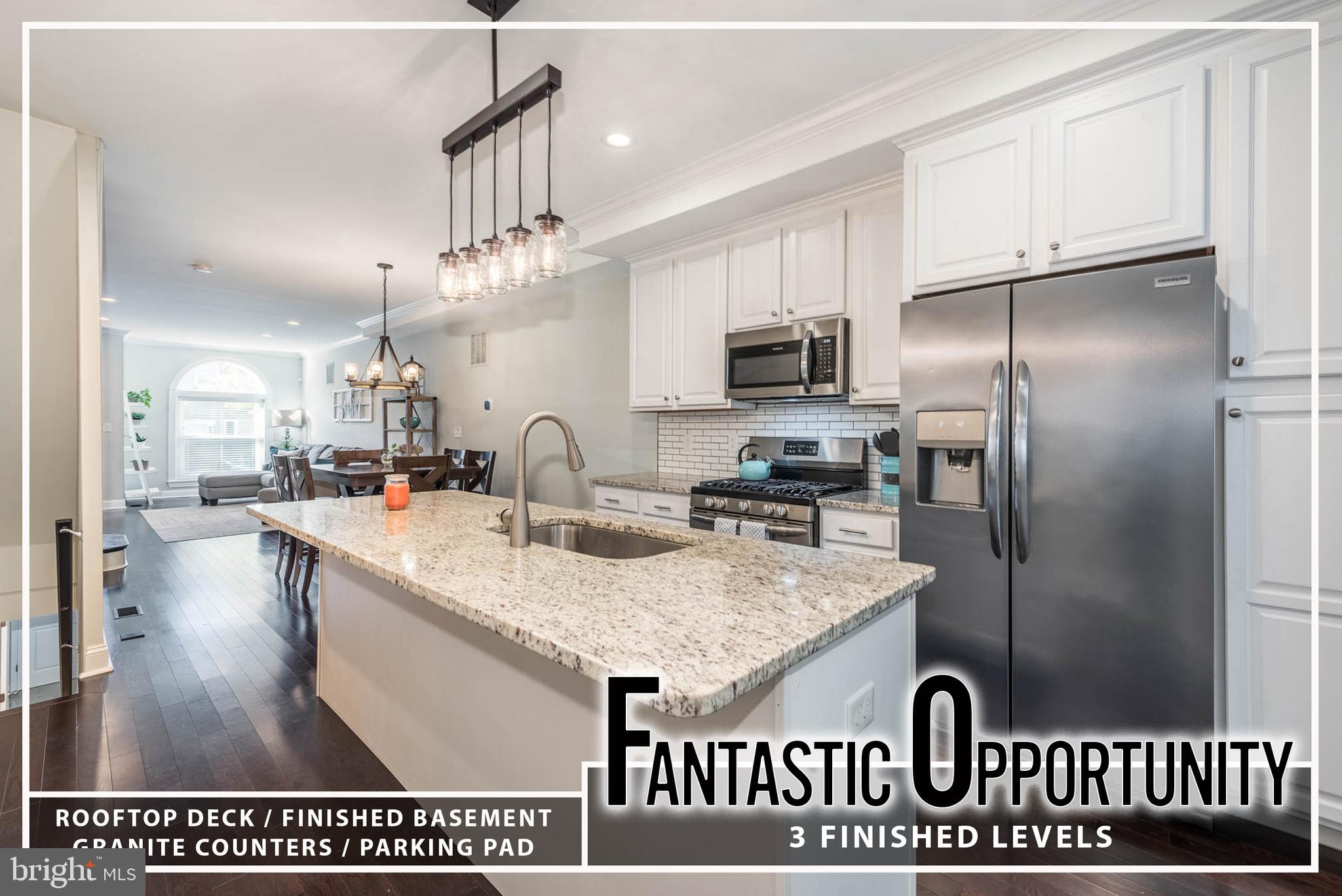 BEAUTIFULLY DESIGNED CHAP TAX CREDIT ROWHOME WITH ROOFTOP DECK & PARKING! 
 Welcome to your dream home featuring an inviting open floor plan perfect for modern living. Enjoy the warmth of hardwood floors throughout the spacious living room, accentuated by charming exposed brick. The island kitchen boasts elegant granite countertops and stainless steel appliances, making it a chef's paradise.  Convenience is key with a main level laundry room and a half bath for guests. Retreat to the primary bedroom suite, complete with a generous walk-in closet and a luxurious full bath.  The finished basement adds valuable living space, featuring a cozy bedroom, a full bath, and a versatile office that could easily serve as a fourth bedroom.  Step outside to your rooftop deck, ideal for entertaining or relaxing with a view. Plus, enjoy the ease of off-street parking. Don’t miss the chance to call this exquisite property home!  Approximately 5 years left of the CHAP Tax Credit - SAVE THOUSANDS!