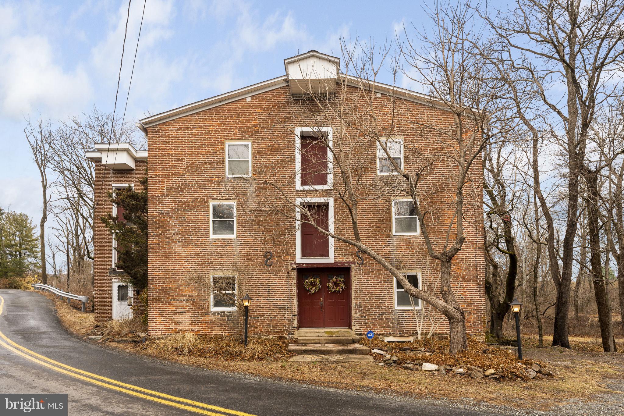 Step back in time with this captivating 1840 stone and brick mill — a remarkable piece of John Penn's legacy — set on 7.35 acres of rolling Barto farmland. This one-of-a-kind property offers a serene escape, featuring a gently flowing stream, a tranquil pond, and stunning views — all within the sought-after Boyertown School District. Whether you're dreaming of opening a bed and breakfast, launching an Airbnb, looking to secure prime hunting & fishing land or simply finding your perfect countryside retreat where wildlife abounds, this historic gem offers endless possibilities to make your vision a reality.

Step inside and be greeted by the grandeur of exposed stone walls, rustic beams and original hardwood floors. The massive living room is an entertainer’s dream, just waiting for your personal touch. The recessed family room, known as “The Pit”, boasts hardwood and slate flooring, along with a stone propane fireplace, complete with a striking copper cover – a true conversation starter. The dining room flows seamlessly into a spacious kitchen, featuring tile flooring, ample countertop space, and countertop seating, perfect for casual gatherings. A full bathroom is conveniently located on the main level. Outdoors, you can barbecue on the deck, cast a fishing line in the pond, explore the woods for hunting, take a refreshing swim in the stream, or enjoy a scenic hike. Back inside, head upstairs to the second floor and find the primary bedroom, featuring a spacious walk-in closet and a huge en-suite bathroom with access from both the bedroom and the hallway for added convenience. Four additional bedrooms provide plenty of room for family and guests. On the third floor, you'll find an enormous attic space — perfect for a recreational room, gym, additional bedrooms/bathroom, or anything else you can imagine. 

Recent updates include a brand-new roof and well, both installed in 2024, a new septic system is in the process of being installed, and a new shed with a workshop provides extra space for hobbies and storage. Enjoy the convenience of being nearby to Route 100 for an easy commute, the Butter Valley Golf Course for leisure and Longacre's Modern Dairy for the best ice cream in town! Don't miss the opportunity to own this truly one-of-a-kind property. Schedule your private showing today and experience the magic of this historic mill firsthand!