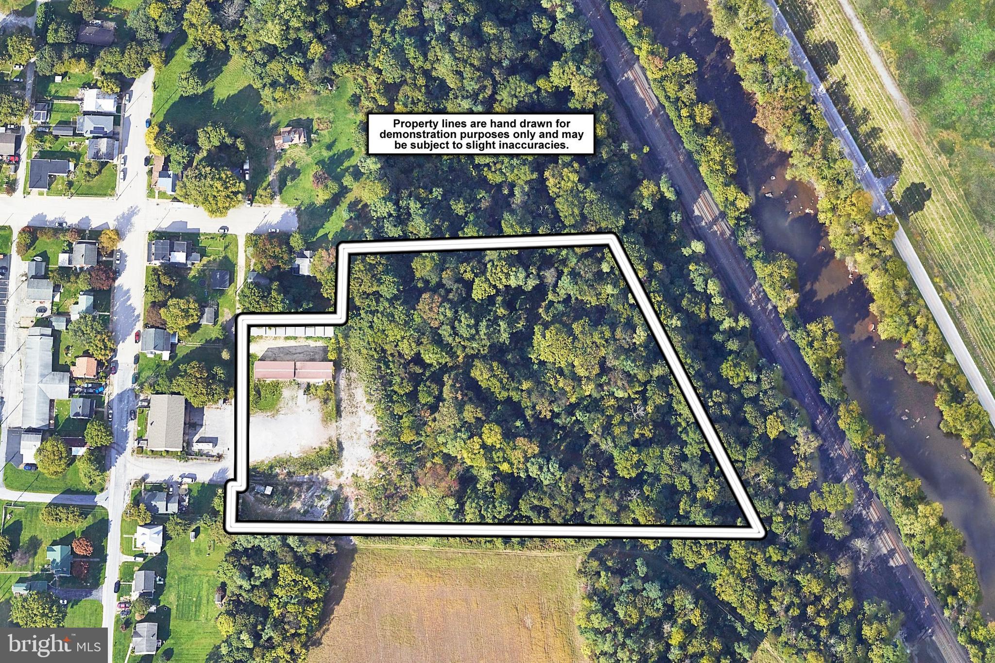 This versatile commercial mini-warehouse complex presents a rare opportunity for investors seeking stable income with strong upside potential. The property features a total of 31 drive-up self-storage units ranging in size from approximately 12'x20' to 14'x24', offering flexible options for renters and consistent cash flow. Additionally, two large warehouse units, each approximately 1,200 sq ft, are equipped with loading docks and drive-in ramp doors—one of which has been recently upgraded with a new edge-of-dock leveler—making them ideal for small businesses or contractors in need of secure workspace and access. Complementing the commercial spaces are two single-family homes on-site, both of which are tenant-occupied and contribute to the monthly rental income. The property also includes 1.5 acres of newly revamped outdoor storage space—graded, cleaned, and now actively being marketed for lease—perfect for RV, trailer, or contractor equipment storage. Current monthly rental income stands at $9,815,  several long-term tenants still paying below market rates, offering immediate opportunities to increase revenue. The entire tenant base is managed through an electronic payment software system, streamlining collections and eliminating the need to handle cash or checks. Since ownership, major capital improvements have been made including new roofing, gutters, and modernization of leases and tenant management systems. The property is zoned Commercial – Mini Warehouse and also includes over 5 acres of additional wooded, commercially zoned land that adds to its long-term value. Operating at a 8% cap rate based on current income—with rising rents and continued lease-up efforts underway—this asset is well-positioned for further financial growth. The owner’s responsibilities are minimal, limited to real estate taxes, exterior lighting, and landscaping for the lower lot, making this a low-maintenance, high-yield investment. Whether you're an experienced investor or expanding your portfolio, this property offers multiple income streams, quality improvements, and a strong foundation for long-term returns.