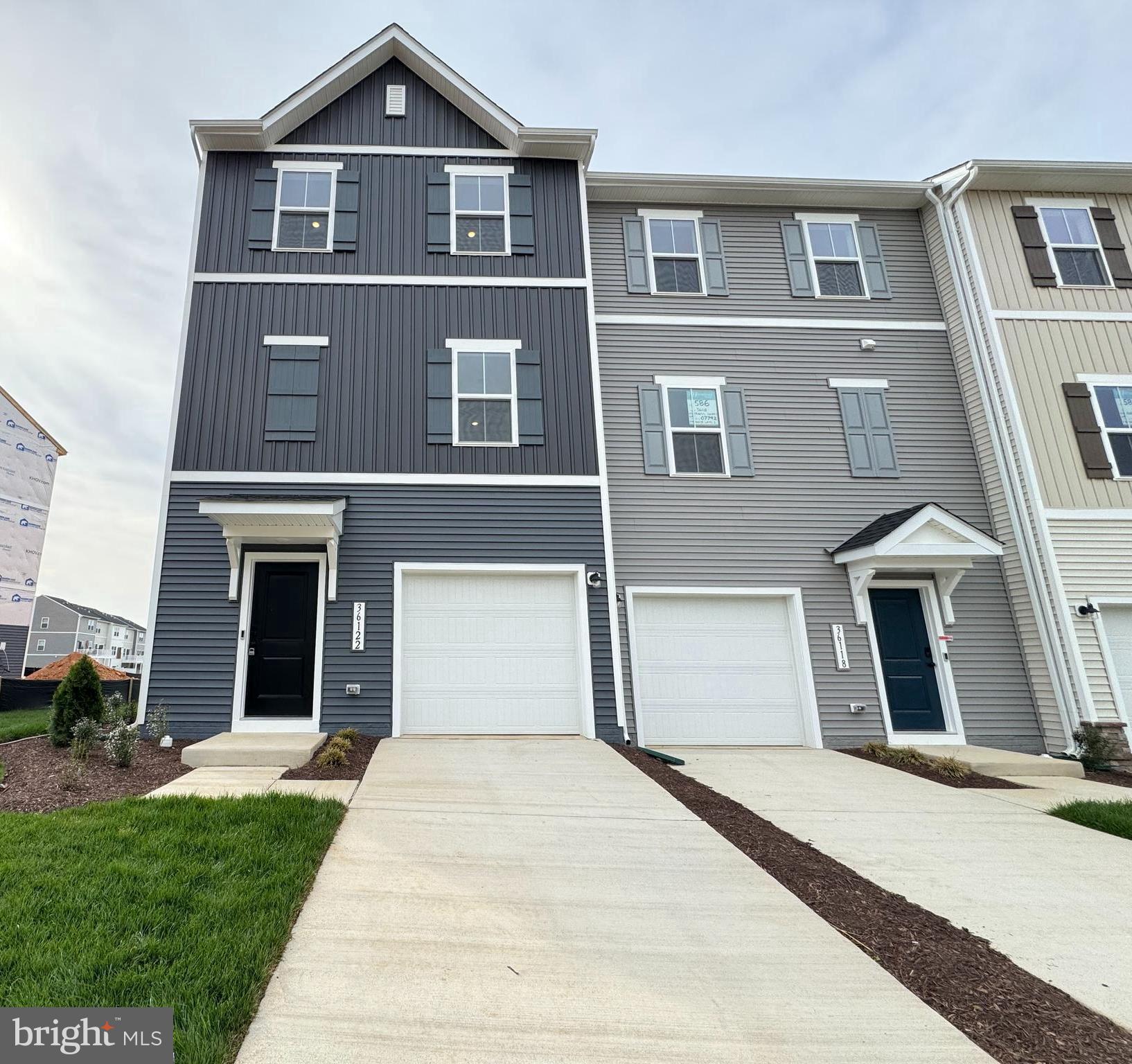 Beautiful, brand new townhome ready for immediate occupancy! This home offers a thoughtfully designed layout with a built-in one-car garage and a versatile activity room with a full bath on the entry level.

The first upper level features a spacious farmhouse-style kitchen with an island and pantry, complemented by stainless steel appliances, upgraded cabinetry, and quartz countertops. This level also includes a bright great room, dining area, and a convenient powder room. The main living spaces are finished with low-maintenance luxury vinyl plank flooring.

The second upper level includes three bedrooms, two full baths, and a laundry area. The primary suite features a large walk-in closet and a private bath with a walk-in shower, upgraded cabinetry, and quartz countertops.
