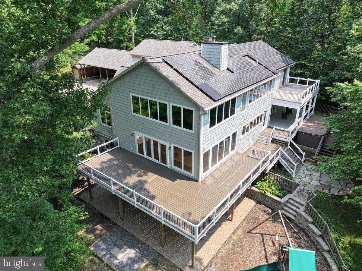 Recently Updated Waterfront Estate on a Private Peninsula in Edgewater
Experience extraordinary privacy, space, and waterfront living in this beautifully updated estate, nestled on its own private peninsula in the heart of Edgewater. Set on 10.77 acres off Beards Creek in Scotts Cove, this remarkable 7-bedroom, 5-bath home offers more than 7,700 square feet of finished living space and a truly one-of-a-kind setting surrounded by wooded conservation easement.

Recent updates in spring 2026 include new CertainTeed Cedar Impressions siding in Coastal Grey, fresh Behr Cotton White interior paint, all new deck railings, and newly laid sod and landscaping. The home is move-in ready, while still offering the perfect opportunity for your own personal touches to make it truly spectacular.

Designed for both comfort and entertaining, the home features window views throughout most water-facing rooms, a main-floor bedroom with full bath and private side entrance, and a private deck that was previously used as a media room and office. Additional special features include a new elevator installed in 2022, four geothermal heat pumps with five zones, tankless water heater, three steam showers, whole-house generator, owned solar panels, and much more.

Waterfront amenities include 665 feet of creek frontage, a private pier, and two boat lifts. With mean low water at 18 inches, this setting is ideal for kayaks and smaller watercraft, and neighborhood discussions have included the possibility of dredging. Approximately 9.12 acres remain conserved, preserving the exceptional privacy and natural surroundings of this unique property.

Located just off Route 2 South, this home offers convenient access to Lee Airport, shopping, dining at the Village at Lee Airport, Route 50, Route 97, Annapolis, Bowie, BWI, and Washington, D.C. With no HOA, R-2 zoning, and an unbeatable private setting, this is a rare opportunity to own a secluded waterfront retreat in an incredibly accessible location.