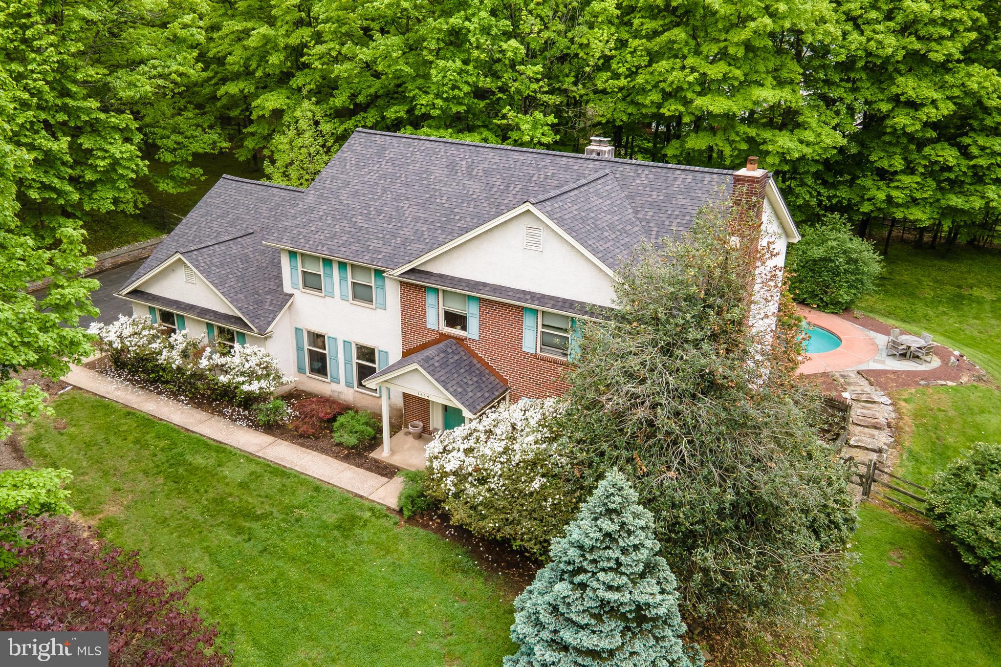 Tucked away at the end of a quiet cul-de-sac and bordering the scenic Wissahickon Trail, this gracious, architecturally designed home offers exceptional space, timeless elegance, and a tranquil natural setting. 
A dramatic two-story foyer welcomes you with exquisite marble flooring and a convenient coat closet. The formal dining room is situated to the left, while the formal living room to the right features a charming wood-burning fireplace. Pocket doors lead from the living room to a peaceful library/home office complete with custom-built bookcases. 
At the rear of the home, the spacious family room serves as the heart of the house, offering a second wood-burning fireplace and additional storage. Nearby, you'll find a powder room and a kitchen featuring vaulted ceilings, skylights, a center island, abundant workspace, and ample room for a large dining table. Sliding glass doors open to a patio overlooking the pool, creating an ideal setting for indoor-outdoor entertaining. Laundry room off the kitchen w/ interior access to the attached two-car garage. 
An elegant staircase ascends from the foyer to a second-floor balcony overlooking the entry below. The expansive primary suite boasts a high ceiling, two walk-in closets, and a dressing room complete with dual sinks, a vanity, and a linen closet. The private bath features a soaking tub and walk-in shower. 
Three additional bedrooms and a hall bath complete the second floor. Two of the secondary bedrooms include walk-in closets. A floored attic with built-in shelving is located above the garage and is accessible through one of the bedroom closets, providing excellent storage options. 
The unfinished walk-out basement offers abundant storage and endless possibilities for future living space, with direct access to the rear yard. Outside, enjoy a beautifully landscaped, fenced backyard designed for both relaxation and entertaining. The inviting patio surrounds the in-ground pool, creating a private outdoor retreat with ample space for dining, lounging, and gathering with family and friends, all framed by mature trees and the peaceful natural surroundings. Combining architectural character, generous living spaces, and a coveted location adjacent to the Wissahickon Trail, this exceptional Gwynedd Valley residence offers a rare blend of privacy, comfort, and outdoor enjoyment. New Roof 2025, New Heat and Central Air 2026, Award winning Wissahickon School District. Close to Restaurants and Shopping, easy access to major highways, Rt 202, Rt 309, Pa Turnpike, SEPTA Gwynedd Valley Regional Train Park and Ride just minutes away.