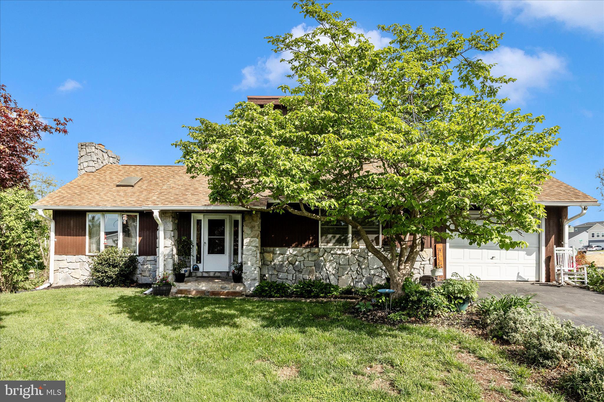 Tucked away on a cul-de-sac in the heart of Thurmont, this striking contemporary home offers a perfect blend of character, comfort, and inviting indoor-outdoor living. Step inside to a bright and airy main level where vaulted ceilings and an abundance of windows and skylights fill the living room with natural light. The stunning stone fireplace creates a warm focal point, making the space feel both dramatic and welcoming. Luxury vinyl plank flooring flows throughout the main level, tying together the open feel of the home. The thoughtfully designed layout includes three bedrooms and two full baths, including a unique loft-style bedroom accessed by a charming spiral staircase (this room needs flooring)—perfect as a guest space, creative retreat, or home office. The primary bedroom offers a peaceful escape with its own skylight and direct access to the expansive rear deck.  Outdoor living truly shines here. A deck that spans almost the entire back of the home and can be accessed from the living room, kitchen, and primary bedroom—ideal for entertaining or simply relaxing. The deck overlooks a private backyard complete with an above-ground swimming pool, creating the perfect setting for summer gatherings. The finished lower level adds even more versatile living space, featuring recreation room with a built-in bar and cozy wood stove. An additional full bath, laundry area, and ample storage space make this level as functional as it is inviting. Walk out directly to the backyard for seamless indoor-outdoor flow.  With its distinctive contemporary style, generous living spaces, and serene cul-de-sac location, this home offers a rare opportunity to enjoy comfort, privacy, and personality all in one beautiful package.