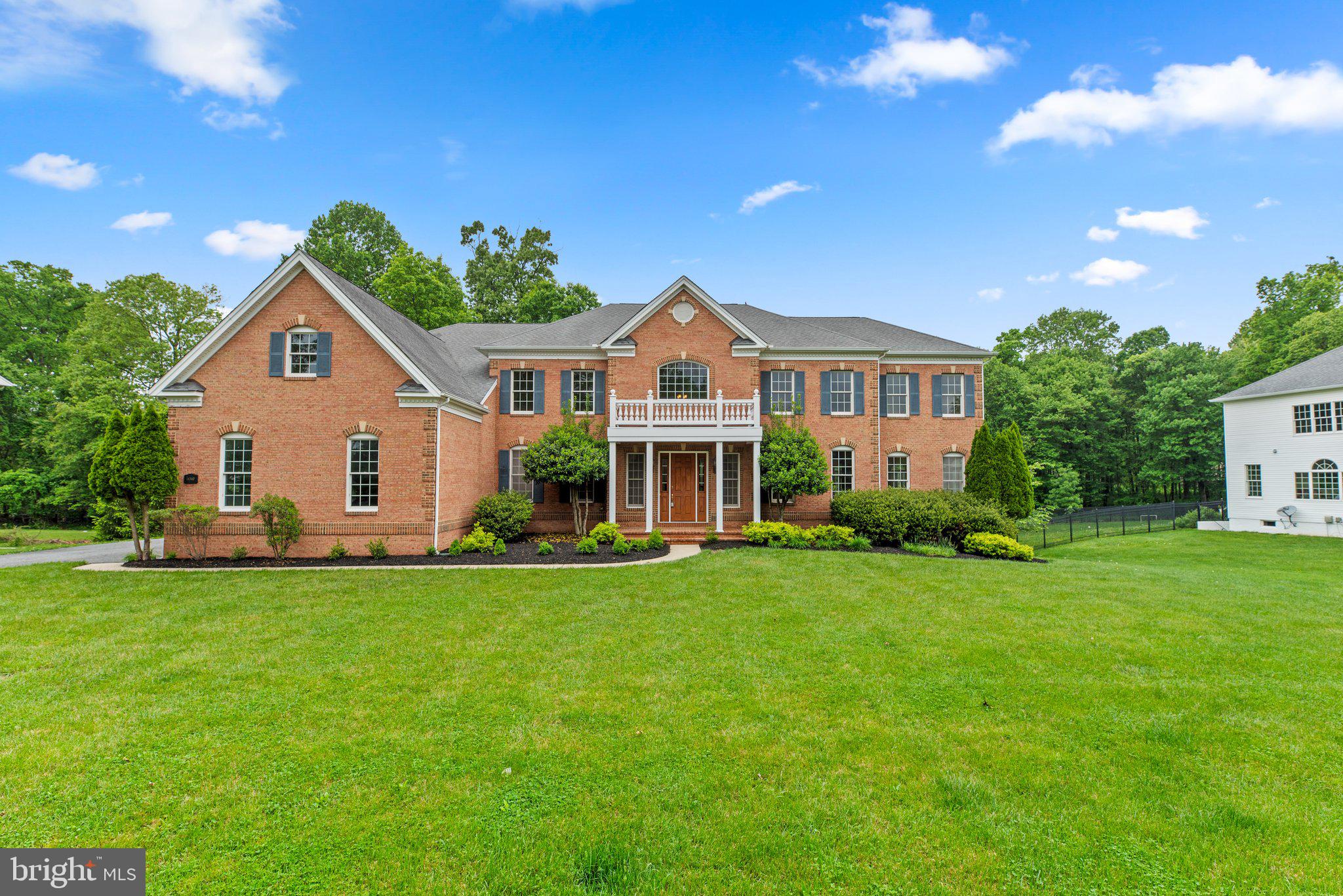 Immediately upon entering the home you are greeted by a gracious dual staircase and two-story foyer
with cool granite flooring opening to a formal dining room appointed with crown moldings and chair
rail trim finished with rich hardwoods that carry into a formal living room or flex space with doors to a
sun filled conservatory displaying a wall of windows capped with Palladian windows.
Entertaining space continues in a conservatory showing abundant natural light and views of the
landscaped yard bringing nature inside via an array of windows topped by Palladian windows.
French doors off the foyer open to a quiet study enhanced by custom built-ins, while the family
room can be found straight ahead, crowned by a two-story ceiling, a casual staircase leading to the
bedroom level, and a central fireplace surrounded by two levels of windows.
Ideal for entertaining, the chef's kitchen provides 42" raised panel cabinetry with under lighting,
granite counters, tile backsplash, a GE stainless steel appliance suite, a center island with a gas
cooktop, a workstation, a peninsula island with a breakfast bar, and an open breakfast room stepping
to deck, with a view of the bay window wall in the sunroom with French door access to a low
maintenance composite deck.
Upstairs, a generous owner's suite presents a column framed sitting room, a lighted ceiling fan, a huge
walk-in closet, and a deluxe garden bath incorporating separate vanities, an oversized shower, a jetted
platform soaking tub, ceramic flooring, and a tray ceiling.
Another aspect to this home is the finished lower level outfitted with additional entertainment areas
highlighted by a rec room with speakers, a game area, a full bath and sixth bedroom, creating a great
option for multi-generational living, and a walkout to the backyard.
Enjoy comfort and luxury in an idyllic retreat in an upscale Howard County community.