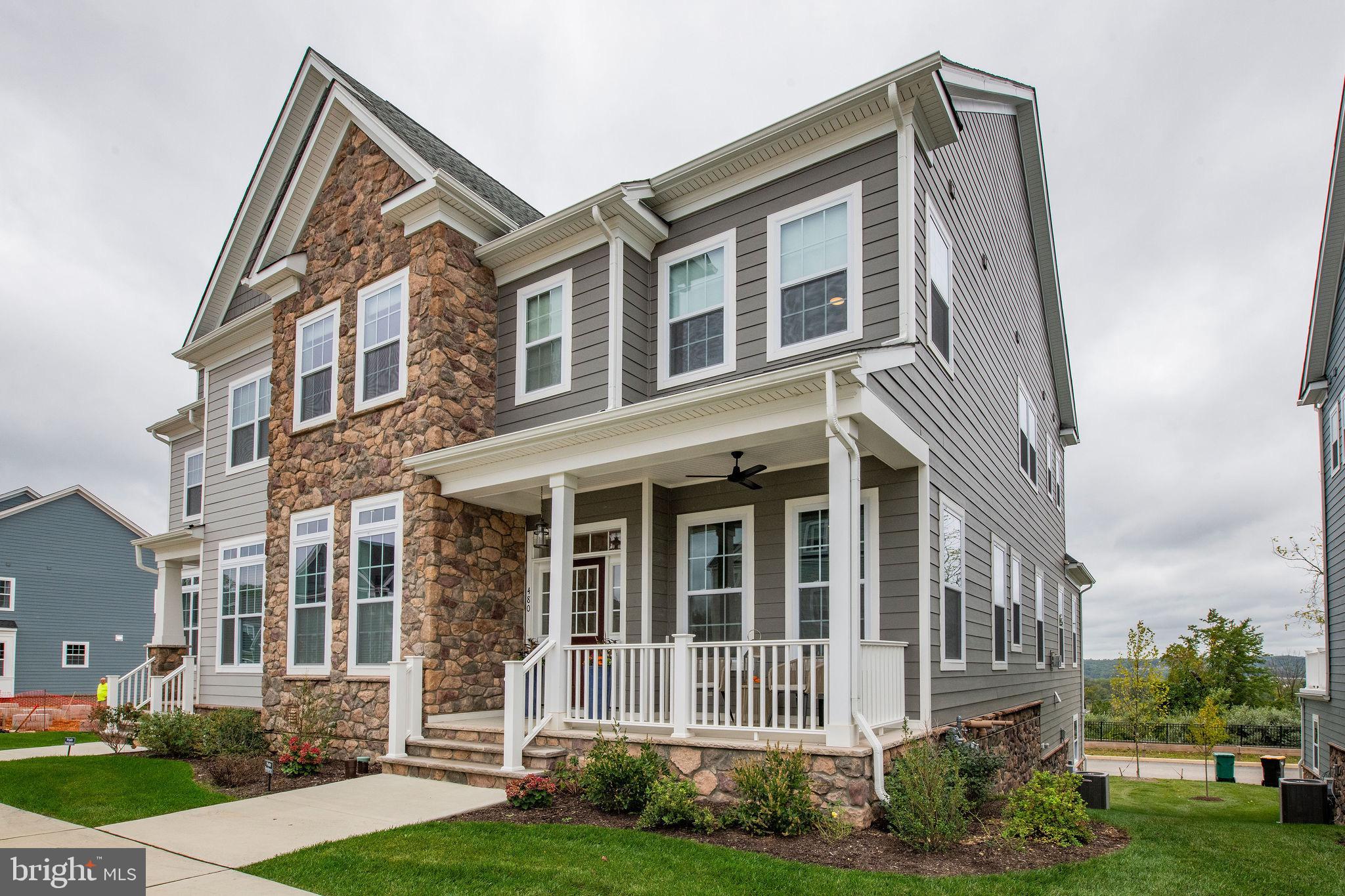 Nestled in the exclusive Spring Oak community, this luxuriously out-fitted Carriage home is a masterpiece of bespoke design and quiet elegance with meticulous designer upgrades. Perched atop the highest ridge of the neighborhood, this home overlooks one of the most picturesque valleys in all of Malvern.

From the moment you enter, the grand scale of the first floor layout offers a generous, spacious and yet warm and welcoming space , with 10′ ceiling heights, exquisite hardwood floors, and even an Office/Library/Guest Suite with a Full Bath.
The open-concept, epicurean-worthy Kitchen features a large Calacatta Miraggio island, surrounded by commercial-grade stainless steel appliances, leathered granite countertops, upgraded designer cabinets with extensive lighting, all perfect for entertaining.
The meticulous attention shown to the Kitchen sets the scene for a seamless transition into the heart of the first level with the Great Room and Dining Room, framed with oversized windows that give unparalleled, unobstructed views of the Malvern valley.
 A front room, reminiscent of a traditional Parlor, or Music Room, connects from the Great Room by way of a handsomely-fitted, decidedly-posh Butler’s Pantry.  Fine touches like the peacock glazed tile backsplash, a hammered copper custom sink, under counter ice-maker, wine cooler and more will make this a conversation starter as much as a delight for entertaining!

Upstairs, the Owner’s Suite beckons as a welome respite, with a generous walk-in custom closet, spa-like en suite accommodations, including separate vanities, a water closet, and a large glass stall shower.
Additionally, two separate en suite Bedrooms, each with a walk-in closet, provide ample comfort and privacy for family members or guests alike. 

Accessed from the street behind the home through a spacious Garage is the finished Basement - comprised of a custom in-home theater, along with all the necessary plumbing in place for a future full Bathroom, and an additional Bedroom that can double as an Office.