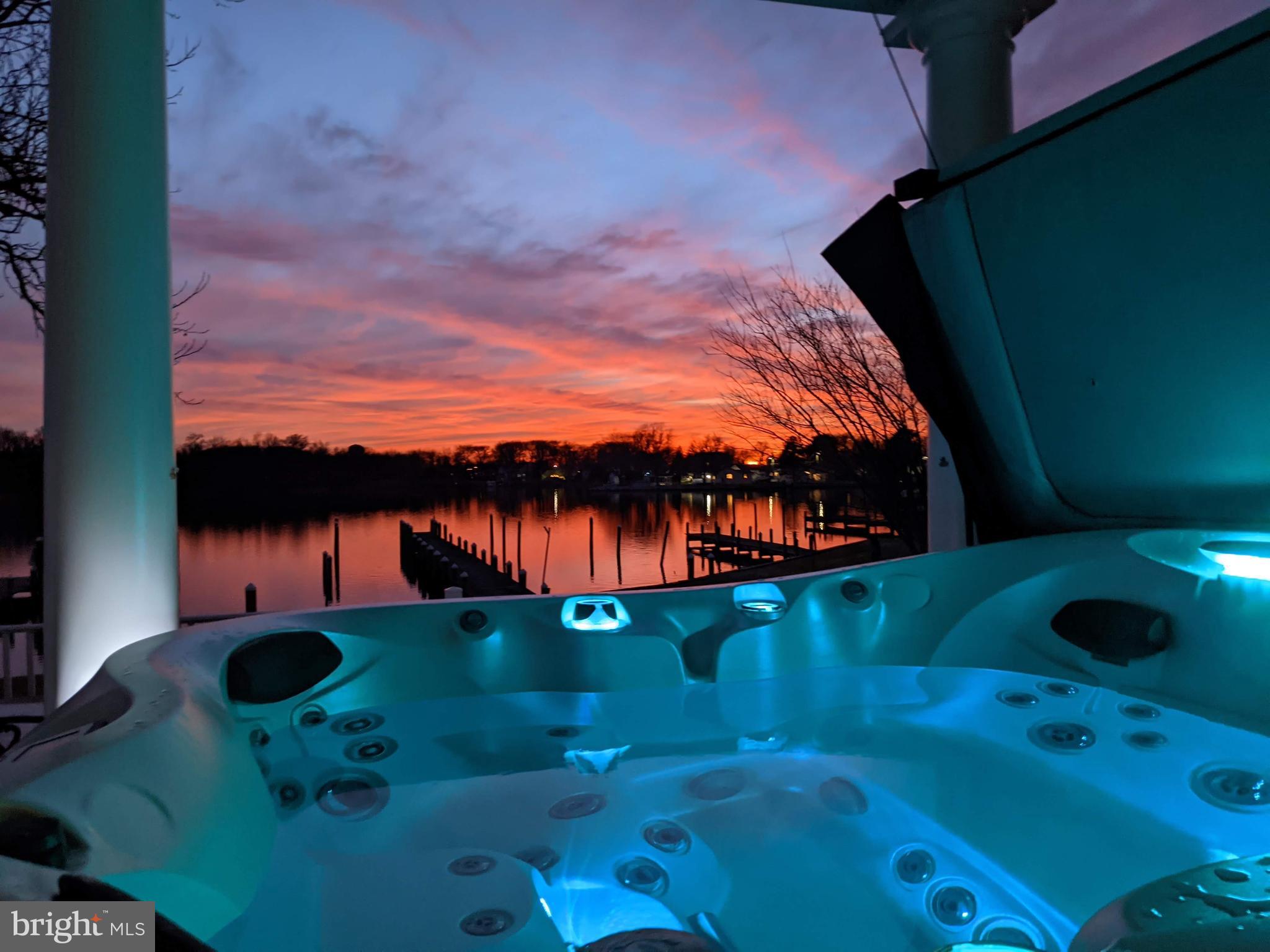 SPECTACULAR! This Carolina Coastal-inspired waterfront home sits on a peaceful peninsula with panoramic Chesapeake Bay views — delivering the waterfront lifestyle most can only dream of.

With nearly 4,700 sq ft of light-filled luxury, soaring ceilings, and walls of windows, you’ll soak in every sunrise and sunset. The gourmet chef’s kitchen features a french door style professional fridge/freezer, double ovens, warming drawer, island, built-in banquette, and walk-in pantry. Beyond the elegant dining room you’ll discover a grand living space with stunning water views and gorgeous maple floors throughout.

Upstairs, the primary suite is the perfect getaway, complete with a spa-like bath, expansive custom walk-in dressing room, vaulted ceilings, and a private Juliette balcony where you can watch the Great Blue Herons, Ospreys, and Bald Eagles soaring over the creek. Enjoy your morning coffee while watching the sunrise in the enclosed sunroom.

The lower level is designed for effortless entertaining, with a bright rec room with double french doors, wet bar with custom oak bar top. Enjoy cozy movie nights in the theater room with lighted tray ceilings (or convert to extra BR). Laundry hook-ups available for true first floor in-law suite potential.

Additional highlights include a library with rolling ladder, pocket doors and balcony, elevator with whimsical touches, loft/office space, oversized garage with epoxy-coated floors and carriage style doors. For your peace of mind, sellers installed brand-new high efficiency Trane HVAC systems, water heater 2yrs new, new Duradek balconies, hurricane rated shingles, hurricane straps on roof trusses. Minimal risk flood ins only $474 year. Huge clean and lighted storage space with concrete floors under the main level. Every detail of this home has been thoughtfully designed and executed.

Outside, the beautifully landscaped yard leads to your private pier, perfect for boating, kayaking, paddle boarding, crabbing or fishing. Or simply relax on the multi-level deck where you can savor the salty breeze from the hot tub.

Tucked in a well established neighborhood that is rich with local history, near 1300 acre North Point State Park and Fort Howard Park, you’ll feel worlds away while staying close to Baltimore, Annapolis, and DC. Boaters will appreciate easy access to top destinations on the Bay.

This is more than just a home — this is a once-in-a-lifetime opportunity to claim a slice of waterfront paradise. Mark Twain said it best. EXPLORE. DREAM. DISCOVER. Come experience coastal small-town living at its absolute finest. Schedule your private showing and make this one-of-a-kind Chesapeake Bay retreat your own!