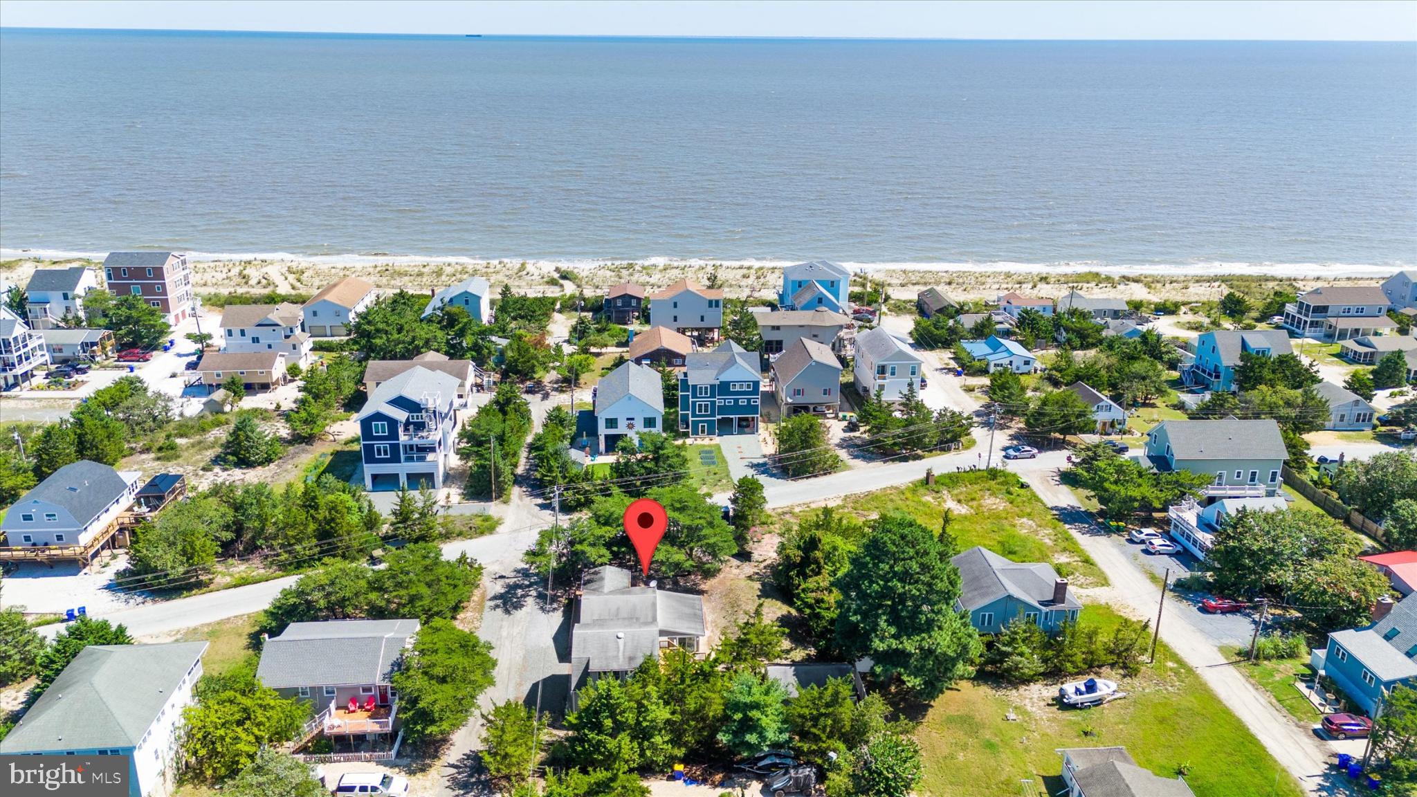 Coastal living in Broadkill Beach. Only a short distance to Lewes. This well cared for cottage offers extra living space with an art studio and oversized detached garage with living space above. Set on a double lot. Just walk across the street to the beach. Features include a sun room surrounded by glass that leads to a wrap around deck. The kitchen is nicely equipped and opens to the living room. The family room offers plenty of daylight. The art studio is a separate building. The garage offers a large living space above, a powder room and laundry closet. An outdoor shower and shed are also included. This property has a lot to offer and is worth a look.