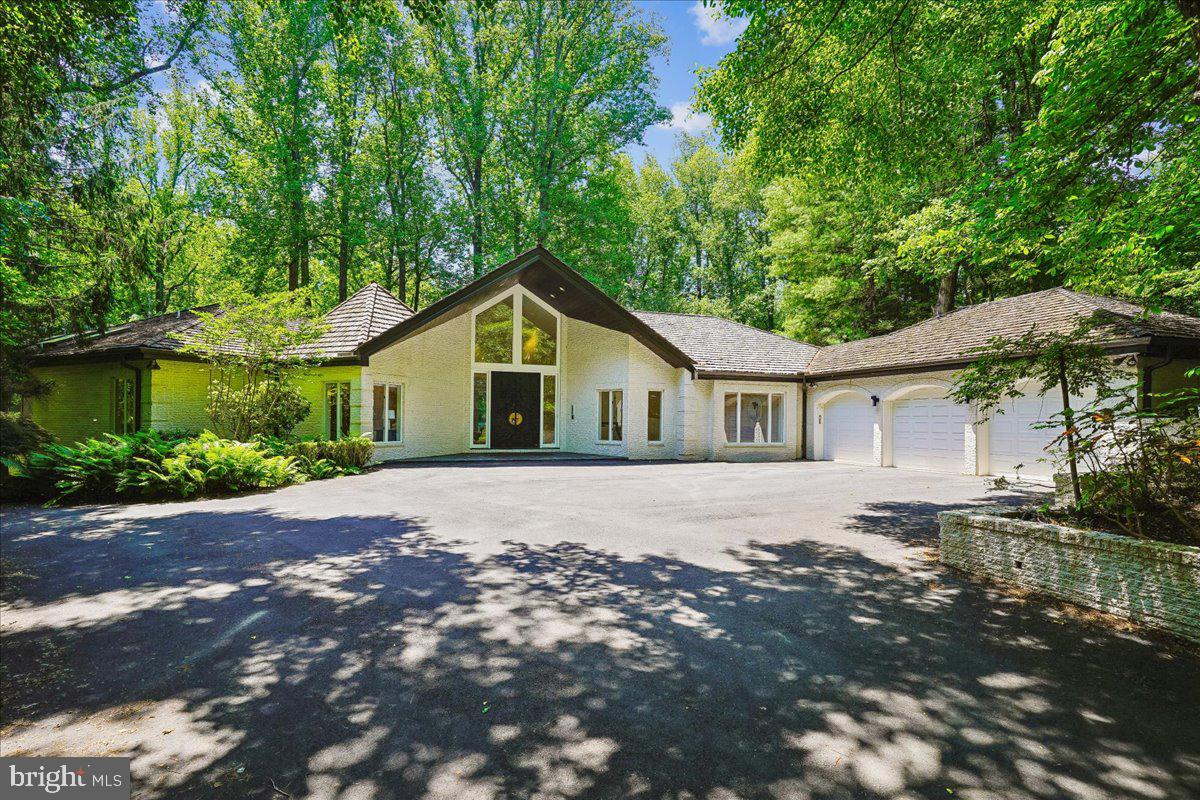 Welcome to 9100 Aldershot Drive—a home that was made for entertaining! This is a super unique opportunity to put your own stamp on this two story home with over 8800 square feet of living space. You will love the privacy, high ceilings, floor to ceiling windows, and backyard oasis.

As you enter the home, you are welcomed by a grand foyer with views of nature straight through to the back of the house. The gracious living room has a fireplace and built in bar, vaulted ceilings, and so much room to mingle and entertain.

The left wing of the main level has three bedrooms and three full baths, an expansive primary suite with two walk-in closets, loads of storage space, and access to the deck from your bedroom.

The right wing of the home has the kitchen with island, a formal dining room as well as a breakfast room surrounded by windows with loads of natural light. On this side of the house, you will also find an additional powder room, mudroom, access to the three car garage as well as a second staircase to the basement.

The basement has been compartmentalized with two offices, a kitchenette, an additional bedroom and full bathroom with walk-in closet, and two rec rooms - one complete with a fireplace and pool table and an additional large rec room. If you do not need the double offices, you could open up the space. There is a tremendous amount of square footage to work with in this two level home!

Finally, step outside to enjoy a super private backyard surrounded by nature complete with a pool, expansive deck, flagstone patio, and built-in bar. If you are looking for privacy yet still want to be close to the city, this is the one for you!