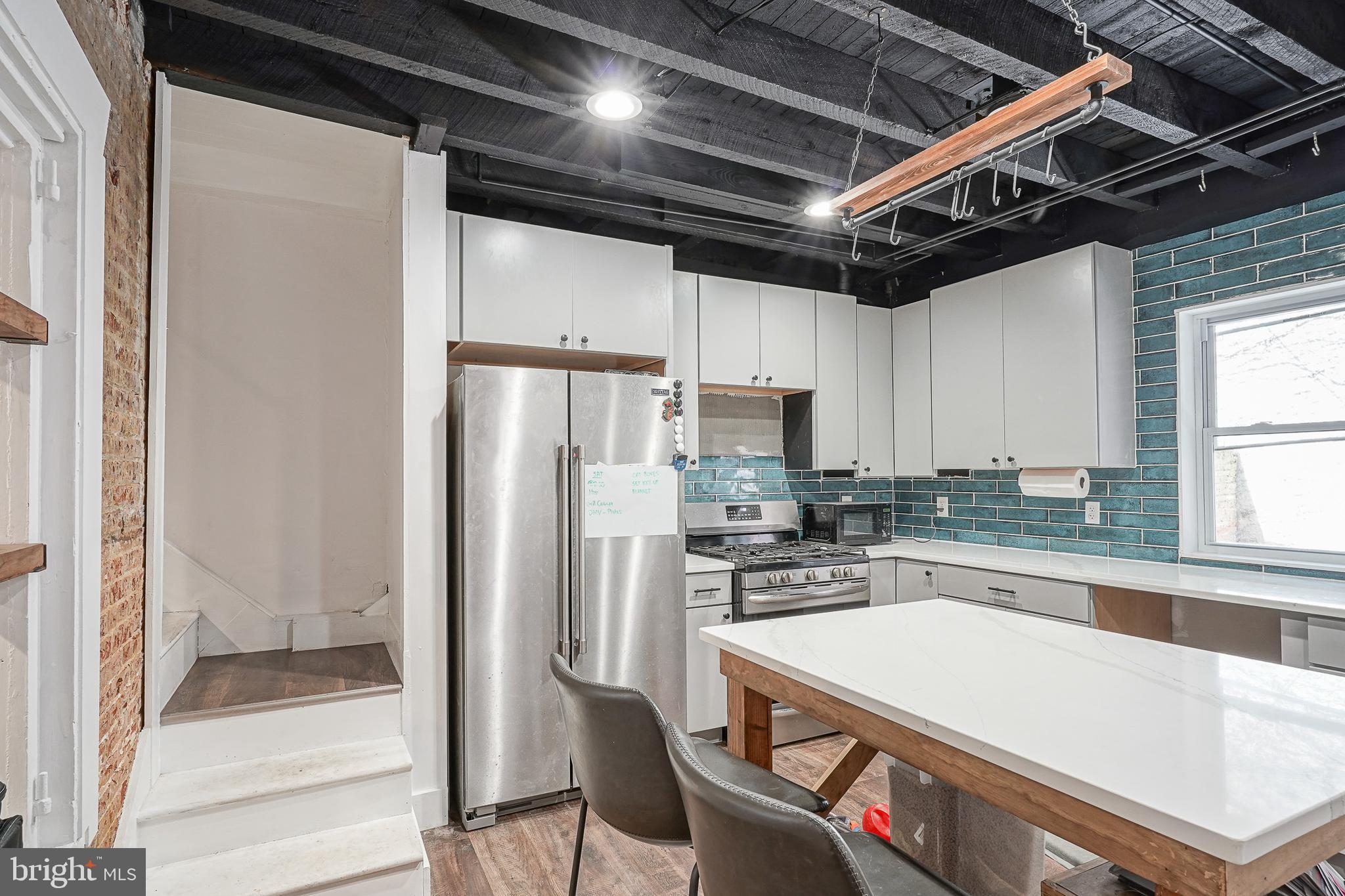 Rare opportunity to own this one of a kind home in the heart of Northern Liberties. This distinctive residence features three stories of living space showcasing beautiful original architectural details throughout, including preserved woodwork, custom built ins, and multiple original fireplaces. Enter to the first floor you are welcomed with the living room accented with built ins and a decorative fireplace, creating a warm and inviting first impression. Just beyond, the spacious eat in kitchen offers an island, exposed brick accents, and plenty of room for everyday dining and entertaining. The second level features two well proportioned bedrooms, including one with an original fireplace, along with a generously sized full bathroom. The third floor offers a loft style bedroom with soaring vaulted ceilings. Outside, enjoy a charming private courtyard with direct street access an ideal setting for morning coffee, dining on warm summer evenings, or creating your own garden retreat. Set within one of Philadelphia’s most vibrant neighborhoods, this home offers a true sense of community. Located near Liberty Lands Park and just moments from the shops, restaurants, cafés, and nightlife that make Northern Liberties so desirable.