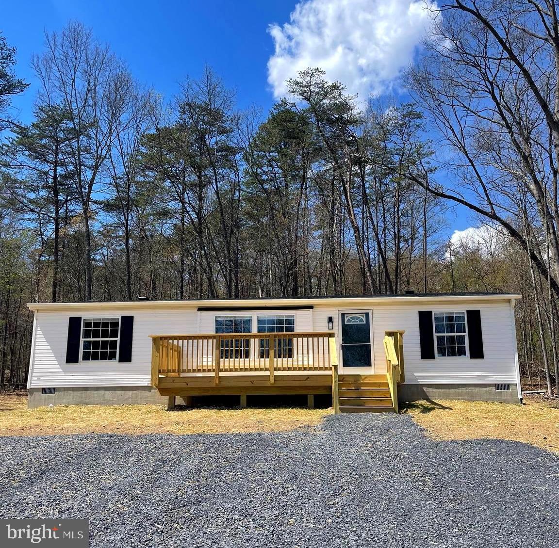 Come take a look at this unrestricted, secluded and private home offering you the peace and quiet you have been looking for! As you turn into the driveway and pull up to the home, you are greeted with a large front porch where you can enjoy your mornings sipping your coffee or the evenings listening to the sounds of nature around you. As you walk in the front door you are greeted with many updated features including new paint, flooring, and kitchen countertops. The open floor plan with your living room, kitchen, and dining area offers you plenty of space to spread out while still feeling included. On one side of the home you will find the primary bedroom and bathroom. On the opposite side of the home you will find 2 more bedrooms and another full bathroom. Off of the kitchen you will find the laundry area with a door leading you out to the back of the home. Outside you are surrounded by trees/woods with a large yard space towards the front of the home. There is a brand new HVAC system, roof, and the well and septic have also just been installed! Don't miss out on all that this property has to offer! Schedule your showing today!