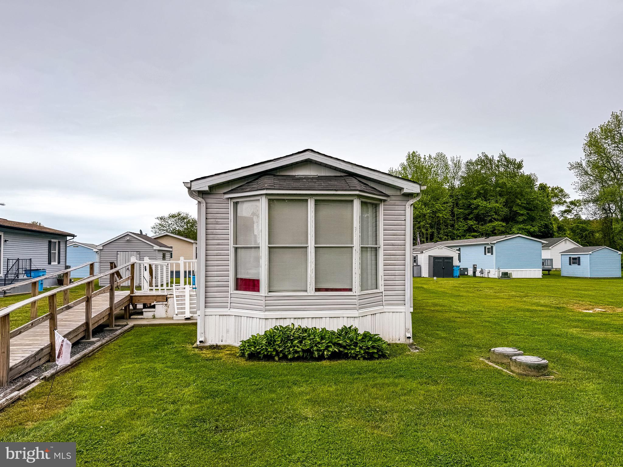 What has 2BR and 1BA, is near the beach, located in a premier community, and is priced at $135,000?    No, it’s not the first line of a great joke.  Although most people would think so, given how many people want this type of scenario..and how rarely it exists.   
Lucky for you, it does exist.   It’s Lot #218 in the Salt Life Community in West Ocean City, MD.  And no, it’s not trying to compete with the polished, fully renovated homes you’ve been scrolling past.  Because what it offers is something different… a real entry point into the beach market.  An entry point nobody else can compete with.
This is a 2-bedroom, 1-bath single-wide home in a senior-living community, sitting on one of the better lots in the neighborhood. End of the street. No neighbor on the south side. More space. More privacy. Less noise.
And the roughly 800 square footage that exceeds many of the smaller  600 sq ft recent sales in the community, you’re getting more room to work with from the start.
Now let’s be clear.
This one needs some TLC.  Hence the price and As-Is sale.
It’s livable. Everything works. Heating and air are in good condition. You can move in tomorrow if you want to.
But it needs attention, imagination, and some effort.
Paint would change everything. A few updates would go a long way. Some time, some effort… and suddenly this looks very different than it does today.
That’s the opportunity.
You’re starting from a price point that’s essentially ‘untouchable’… and deciding what comes next.
The Salt Life Community is a West OC land-lease community that offers a different kind of lifestyle than most buyers expect at this price point. A waterfront pool, bathhouse, gazebo with lounge areas, outdoor kitchen and fireplaces, plus a boardwalk, fishing pier, and small beach area… all built into a setting that keeps you connected to the water without the cost of direct ownership.
And the location does the rest.
West Ocean City puts you minutes from the harbor, boat ramps, restaurants, shopping, and a straight shot into Ocean City’s beaches and boardwalk, as well as Assateague Island and downtown Berlin. It’s one of the most convenient positions on the shore, especially for something at this price.
The monthly land lease of $740 includes property taxes, water, trash, and community maintenance, keeping ownership simple and predictable..
This is for the buyer who understands what $135,000 at the beach actually looks like… and sees how easily it could become something that’s SO MUCH better.