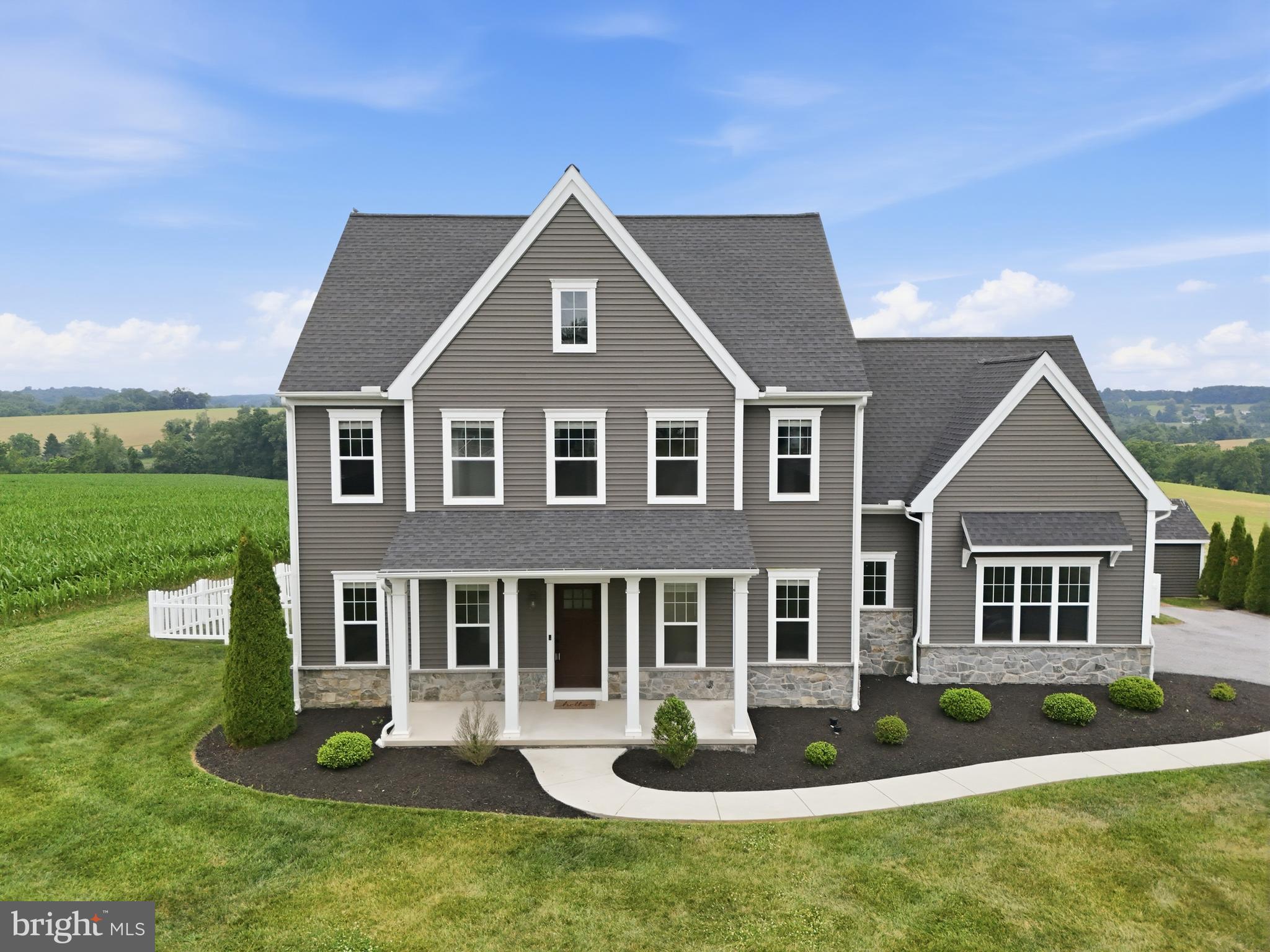 Welcome home to this stunning 4-bedroom, 2.5-bath colonial offering over 3,000 square feet of finished living space in Southern York County School District! Built in 2020 and ideally located just minutes from the Pennsylvania/Maryland line, this home provides the perfect balance of peaceful rural living and commuter convenience, with easy access to shopping, dining, entertainment, and everyday amenities.

Outdoor enthusiasts will love being just a short drive from the renowned NCR Rail Trail, offering miles of scenic hiking and biking paths, as well as numerous local breweries, restaurants, and attractions throughout Southern York County and Northern Maryland.

Step inside to discover a spacious open-concept main level designed for both everyday living and entertaining. The kitchen, dining area, and living room flow seamlessly together, creating a bright and inviting atmosphere. The living room is highlighted by a recently completed custom accent wall surrounding the gas fireplace and mantle, creating a beautiful focal point for the space. The kitchen features a large island with bar, pantry, tile backsplash and stainless steel appliances. Just off the attached two-car garage, you'll find a convenient drop zone for coats and shoes, along with a main-level half bath.

Upstairs features four generously sized bedrooms, including a spacious primary suite complete with TWO walk in closets and a private en-suite bath featuring a dual-sink vanity. Three additional bedrooms offer ample closet space, and the second-floor laundry room adds everyday convenience. There is another full bath also with a dual sink vanity off the main hall to complete this level. 

Need even more space? Half of the basement was just finished this month and features new LVP flooring, fresh paint, and finished walls, making it the perfect flex space for a bonus room, home office, playroom, gym, or media area.

Outside, enjoy a fully fenced backyard overlooking panoramic views of rural Southern York County farmland AND the sunsets are TO DIE FOR! A storage shed provides plenty of room for lawn equipment and seasonal items, while the oversized driveway and attached two-car garage offer abundant parking.

Best of all—NO HOA! Homes offering this much space, modern construction, and a prime Southern York County location rarely become available. Don't miss your opportunity to make this beautiful home yours!