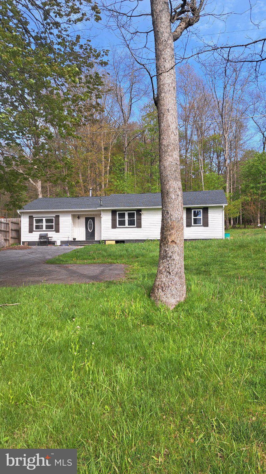 This charming 3-bedroom, 1-bathroom ranch-style home in the desirable Oakland Sang Run Rd area near the Youghiogheny River offers a blend of modern upgrades and classic appeal. Recently renovated in 2022, the interior features an open floor plan with luxury vinyl tile flooring, built-ins, and a gourmet kitchen equipped with stainless steel appliances and upgraded countertops. Enjoy the convenience of main floor laundry and double-pane windows for energy efficiency. Set on a generous 4.88-acre lot, the exterior includes an outbuilding and a wood/metal shed, perfect for storage or hobbies. The property provides ample driveway parking and a serene outdoor space for relaxation. Located in a vibrant community, residents benefit from nearby parks, excellent schools, and convenient public services. This home is ideal for those seeking a peaceful retreat with easy access to local amenities. Don't miss the opportunity to make this property your own!