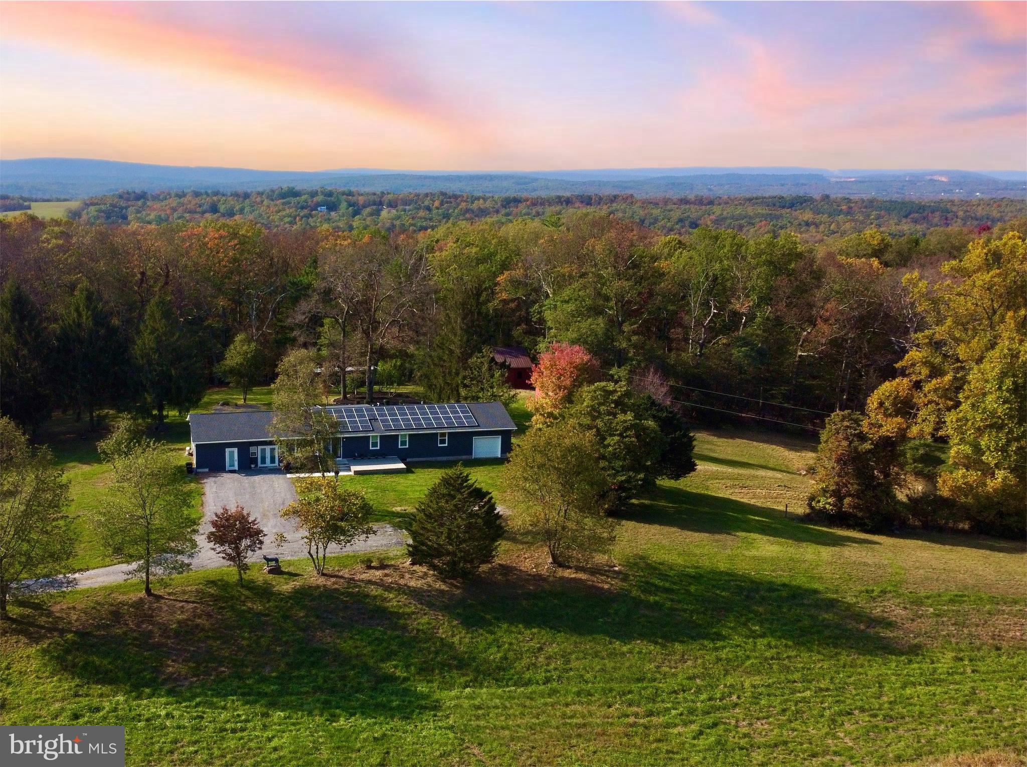 RARE opportunity to own a fully off-grid capable ranch home on 7 unrestricted private acres at the base of Sleepy Creek Wildlife area surrounded by scenic and peaceful views with abundant wildlife. This home has lovingly been renovated with over $400k in upgrades, providing a perfect living space for a family. The current owner purchased it for her parents, but following her father's passing and her mother's decision to move in with her, the home is no longer needed for their use. Shes looking to pass this beautifully updated property on to new owners who can appreciate all the care and attention that has been put into it. Updates that include a new roof with solar panels, new energy efficient windows and doors, new insulated siding, new central air and HVAC, Arlo multi-camera security system, reverse osmosis water system, entire house has been rewired with updated electrical to VA code, and a finished basement with waterproof French drain system and automatic sump pump. The solar panels provide enough power to offset the electric bill due to the multiple Tesla power wall storage batteries.  Currently, the home is still connected to Potomac Edison and pays only the 5$ fee to stay connected to the grid, but this home has the ability to be fully functioning off grid if needed. The home has 5bedrooms, 3 full bathrooms, an office, main level laundry room with new washer and dryer, large dining room and kitchen with new appliances (stove, dishwasher, refrigerator), living room, all season sunroom, and large finished basement with work area and separate access. There is a 1 car pass through garage, a 12x28ft separate work shed plus a barn with a stall and an additional pole barn. This amazing home is 10 minutes from downtown Berkeley Springs, a hospital, Walgreens, and groceries. The home currently has high speed, unlimited internet access through Starlink (Speed 100+ mbps, typically close to 150-200mbps). Starlink account will transfer upon request.

Ask your agent to see document section