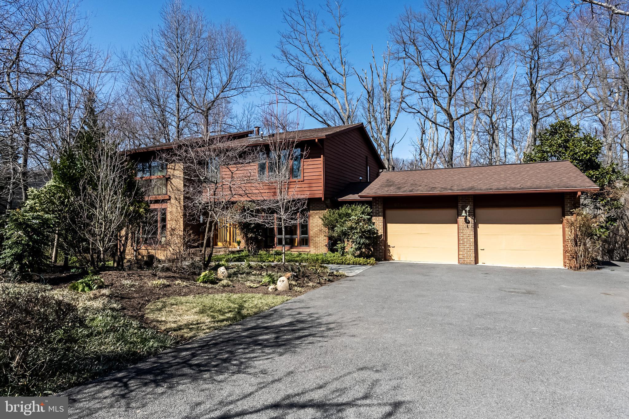 Open Sun 3/30/25 - 1-4PM:  Nestled in a serene 1/3 acre park-like setting, this approximately 4,500 sq. ft. 5Bdrm/3.5Bath beautifully expanded & updated contemporary home, seamlessly blends modern elegance with nature's tranquility.  As you step inside you are greeted by high-end quality finishes, including hardwood flooring, ceramic tile, and plush upgraded carpets. The open-concept, clean lines, sleek finishes and modern design elements make for an appealing and gracious living environment. There is a lovely living room and separate dining room off the foyer. The jaw-dropping family room at the heart of the home features a soaring ceiling, gas fireplace, and a unique elevator to the open loft and bedroom level above. The expansive windows & skylights allow for wooded views and invite an abundance of natural light in. The gourmet kitchen, with an inviting breakfast room, is updated with state-of-the-art stainless appliances & granite counters. A stylish and upgraded powder room and a huge laundry/mudroom with ample storage can also be found on the main level. The living space flows effortlessly onto the newer 650 sq. ft. exterior rear decking where you can entertain or unwind surrounded by your own private backyard sanctuary.  The upper level features a well-appointed primary suite with renovated luxury en suite bath, and three additional bedrooms (one used as a home office), and updated hall bath. The lower level boasts a spacious recreation room with walkout to rear patio and yard, an exercise/bonus room, a large guest suite and full bath, plus great storage. This well-maintained property has undergone significant enhancements under the ownership of renowned architect C.R. Dove, with so many special features that add value and allure. An expansion encompassing all three levels, including the impressive double decking, not only increased the living space, but also the aesthetic appeal.  The addition of the two-level interior tubular elevator offers convenience, flexibility and accessibility, catering to a broader range of potential buyers.  All windows and doors have been recently replaced with top-of-the-line Pella products, ensuring superior energy efficiency, noise reduction, while enhancing curb appeal & value. All in a desirable location and neighborhood you will cherish, conveniently close to shops, services, parks, recreation, entertainment venues, schools, Metro/transit and commuter routes. Welcome home!