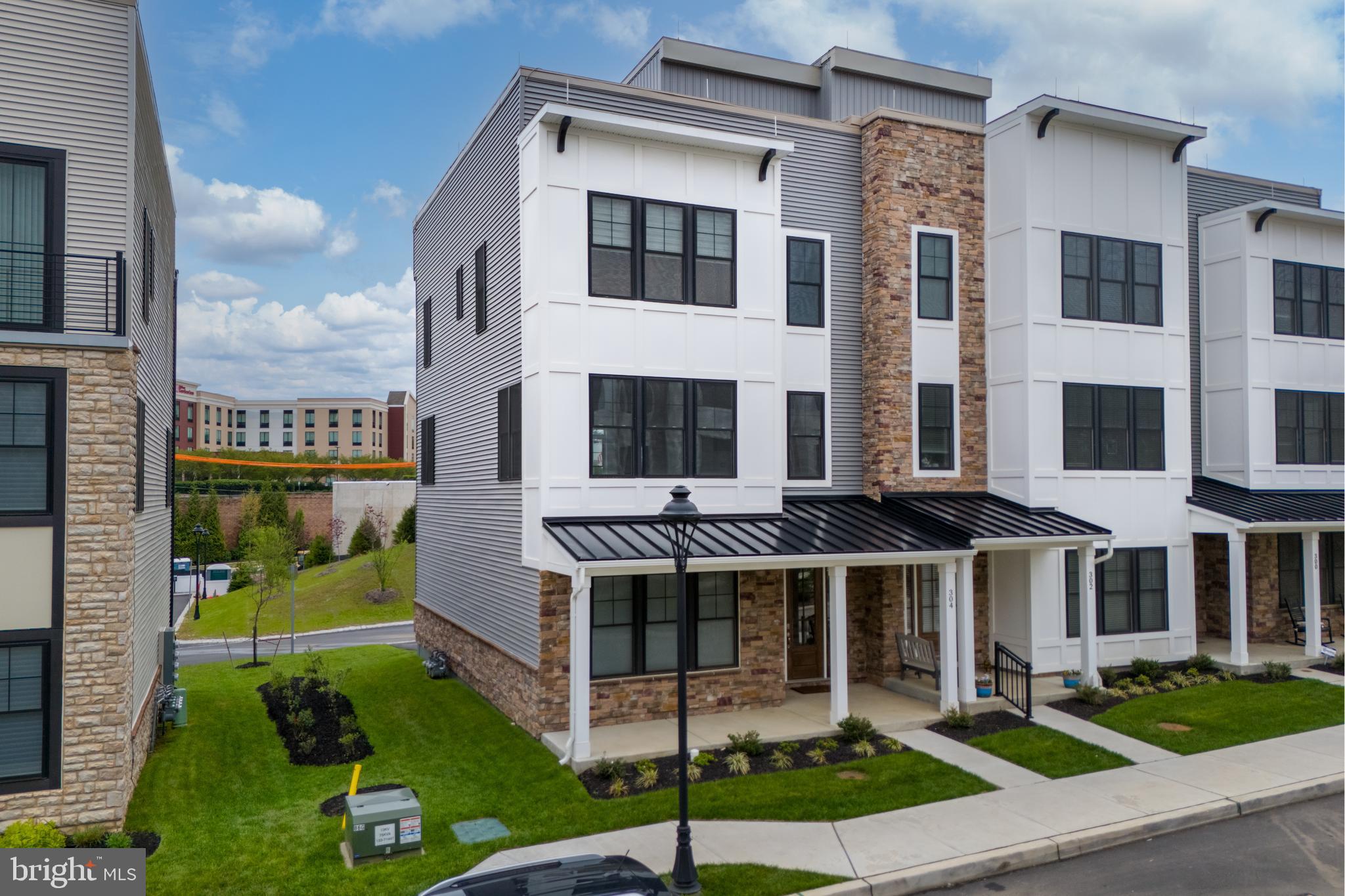 Welcome to 304 Squire Drive: A Luxurious End-Unit Townhome in Newtown Walk at Ellis Preserve

Discover unparalleled elegance in this custom 4-bedroom, 3.5-bath end-unit townhome, located in the highly sought-after Newtown Walk community within Ellis Preserve. With modern design and upscale finishes, this home offers the perfect blend of comfort and style.

The first floor features 9-foot ceilings and offers a generously sized bedroom with an ensuite bath and plenty of storage, along with convenient access to the 2-car garage.

The main living level boasts 10-foot ceilings, with an abundance of natural light streaming through windows on all three sides. The open-concept design includes a gourmet kitchen that is a cook’s dream, featuring upgraded 42” black cabinetry, quartz countertops, a 10-foot island, Wolf induction stovetop and oven, stainless steel refrigerator, and a built-in microwave. Additionally, the kitchen is equipped with a reverse osmosis water system and a whole-house water filtration system for added convenience.

Adjacent to the kitchen, the spacious dining area comfortably accommodates a large table, making it perfect for entertaining. The great room features a cozy gas fireplace and offers ample space for hosting guests.

On the upper level, the primary suite provides a luxurious retreat with an oversized ensuite bathroom, complete with heated floors, upgraded tile, and a floating vanity. The expansive walk-in closet offers more than enough room for two people to share. Two additional bedrooms, a hall bathroom with heated floors, and a laundry room complete the third floor.

The showstopper of this home is the expansive rooftop deck, designed for both relaxation and entertaining. This incredible outdoor space features ample room for seating and dining, plus a custom pergola with a fan for added comfort.

Throughout the home, automated blinds provide an additional touch of luxury and convenience.

Parking is a breeze with a 2-car garage and a 2-car driveway, offering ample parking for homeowners and guests.

Nestled in the desirable community of Ellis Preserve, this home boasts walkability to local shops, restaurants, and fitness boutiques, along with scenic walking trails. With close proximity to major transportation routes, local schools, shopping, and the airport, this home truly has it all.

Don’t miss your opportunity to own this stunning, move-in ready home in a prime location!