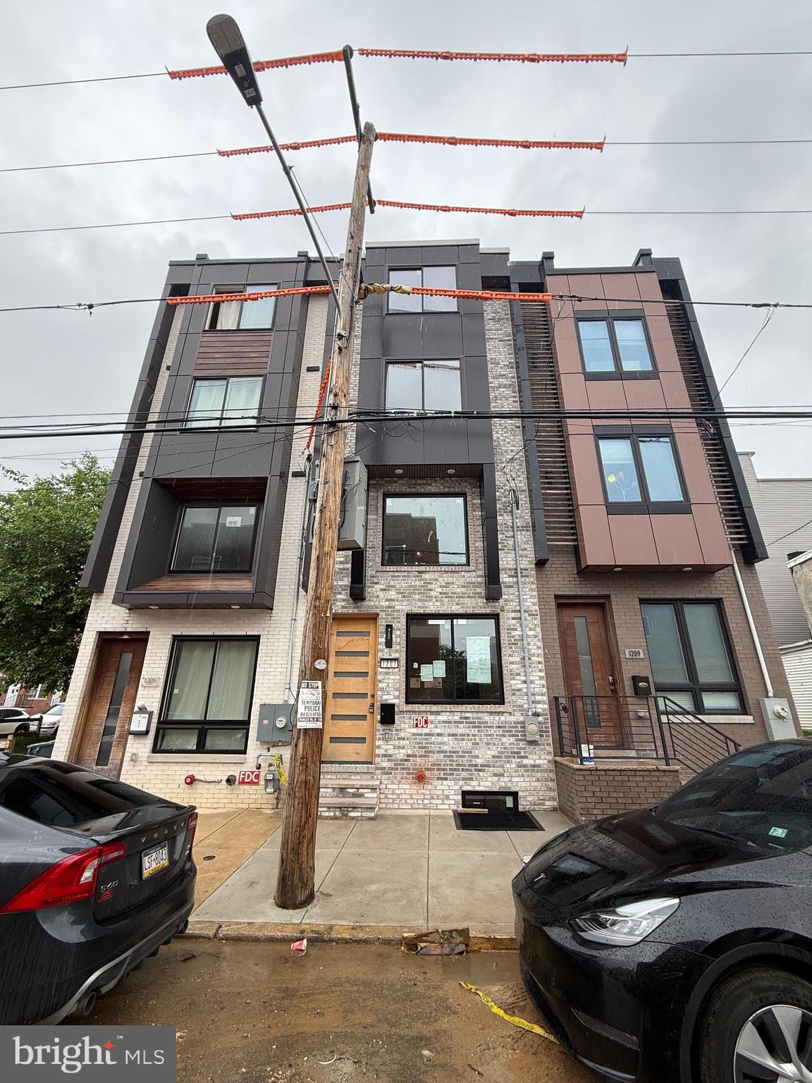 Still under construction. Will be completed Very soon! Welcome to this stunning custom-built newer construction home located in the heart of the Grays Ferry section of Philadelphia. This thoughtfully designed four-story residence offers an exceptional blend of modern luxury and functionality. Step into a bright and spacious living room that seamlessly flows into the dining area and a beautifully appointed contemporary kitchen—perfect for both entertaining and everyday living. Just off the kitchen, you'll find access to a cosy, and private rear patio. The mezzanine level features a secondary living area or den and a half bath. Upstairs, two generously sized bedrooms and a full bathrooms offer comfortable living quarters. The top-level is home to the private primary suite, complete with a custom walk-in closet and a spa-inspired bathroom featuring a soaking tub and elegant finishes. Just a few steps more, you will have access to your private rooftop. Take in breathtaking views of the Philadelphia skyline from your rooftop deck, which includes a built-in hot tub and ample space for relaxing or hosting guests. The fully finished basement provides additional flexible space, including a potential fourth bedroom, office, gym, or media room, along with a full bathroom, and utility room. Property also has Tax Abatement. This home is ideally situated close to the UPenn, major highways, public transportation, the airport, shopping, and some of the best that Philadelphia has to offer. Don’t miss this opportunity—schedule your private tour today!