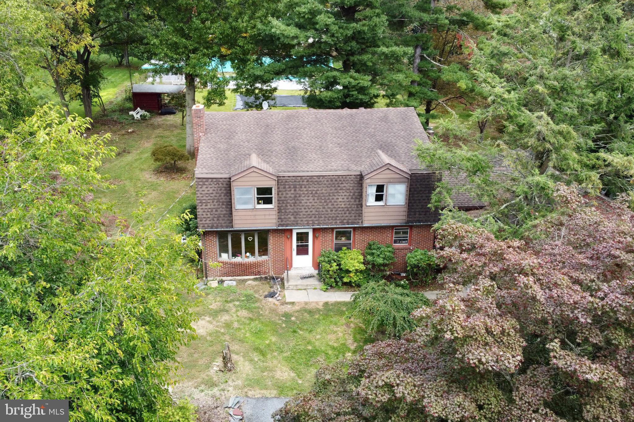 High interest rates got you down? Here’s the solution: purchase this home and assume the current 2.6% FHA mortgage! Featuring 3,000+ sq ft on 1+ acre in Lower Saucon Twp, just outside of Hellertown Borough, it boasts 5 spacious bedrooms and 2 full bathrooms with a 3rd waiting to be finished. Relax in front of the living room fireplace or entertain in the large dining and family rooms. When summer comes, head outside to enjoy the spacious backyard with plenty of mature trees or take a dip in the enormous 20'x40' in-ground pool at the rear of the property. The full-sized 2-car garage has room for cars and toys alike while the attached carport area provides additional covered parking. This is a solid home and great property, but does require work as the sellers were mid remodel when opportunity knocked requiring them to relocate.
