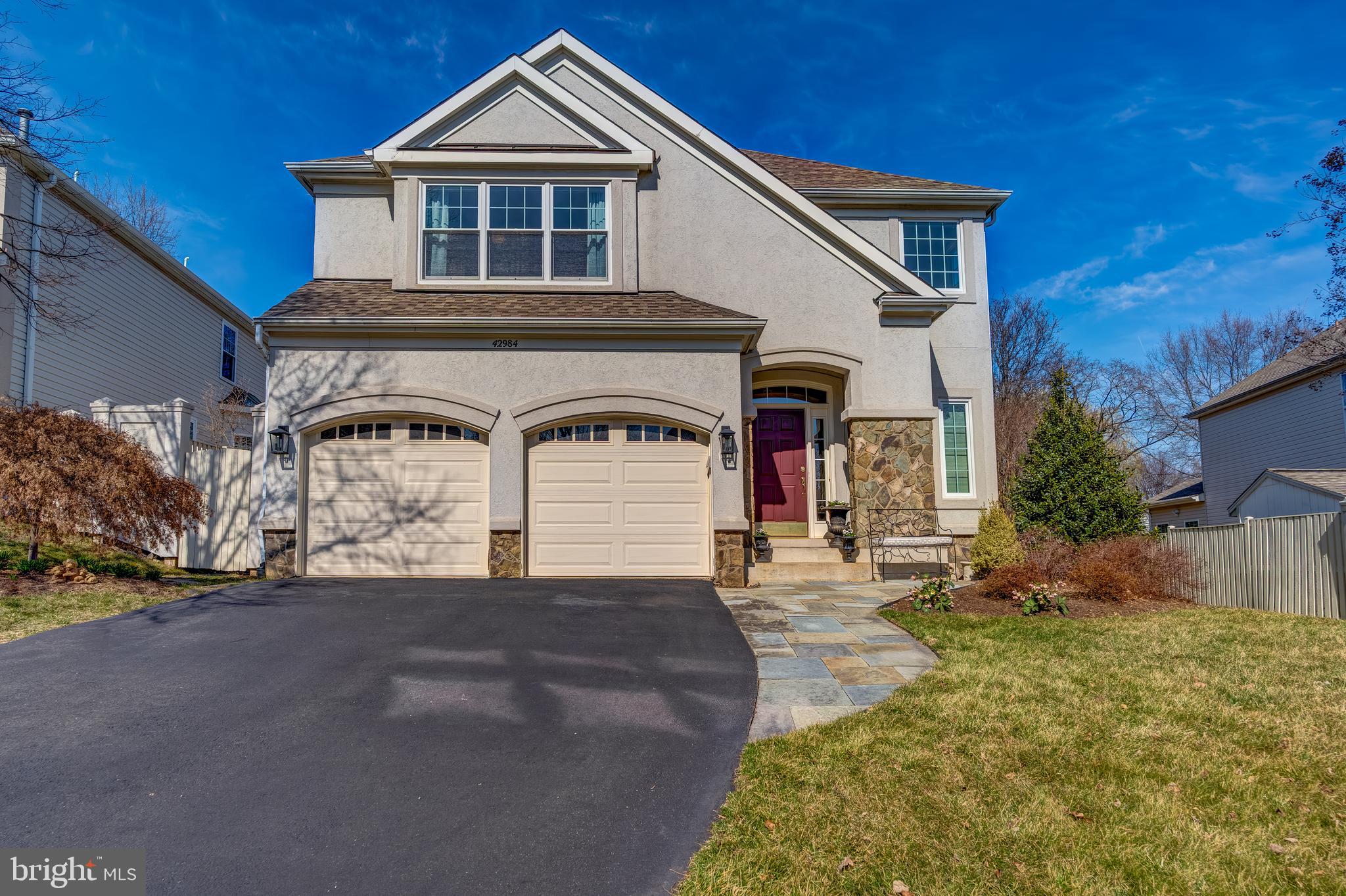 Welcome Home! This stunning 4,600+ sq. ft., 3-level, 4-bedroom, 4.5-bath, 2-car garage single-family home in Ashburn Farm is ideally situated within walking distance to the sought-after Stone Bridge High School. Thoughtfully updated, this home features  updated kitchen and bathrooms, blending modern style with everyday functionality. Designed for comfort and elegance, the home boasts spacious, sun-filled rooms and gleaming hardwood floors throughout the main level, creating a warm and inviting atmosphere.

The two-story living room offers an impressive sense of space, complete with a cozy fireplace. The family room, located off the kitchen, provides direct access to the deck and backyard, making it the perfect spot for entertaining or relaxing. The updated kitchen is a chef’s dream, featuring white shaker cabinets, a subway tile backsplash, a large island, and stainless steel appliances. A custom pantry/mudroom was added off the kitchen, providing extra storage and organization while enhancing the home’s functionality. Adjacent to the kitchen, the large dining room is perfect for hosting family gatherings and special occasions.

Upstairs, you’ll find four generously sized bedrooms and three full bathrooms, including a spacious primary suite with two walk-in closets and a luxurious en-suite bath. The spa-like primary bath features a frameless glass shower, a 72-inch dual vanity, a standalone soaking tub, and elegant 12” x 24” tile flooring. One of the secondary bedrooms includes its own en-suite updated bathroom, while the remaining two bedrooms share a beautifully updated hall bath.

The fully finished lower level is designed for relaxation and entertainment. It offers a recreation room, a flex space, a full updated bathroom, and plenty of storage, making it the perfect retreat for guests or extended family.

Step outside to the fully fenced backyard, where a new Trex deck overlooks mature trees, offering both privacy and scenic views. The beautifully maintained landscaping is complemented by a lawn irrigation system, ensuring lush, green grass all season long.

For peace of mind, all major systems have been recently updated, including the roof, HVAC, and hot water heater, so you can move in worry-free.

Situated on a quiet cul-de-sac, this home offers direct access to walking trails and green spaces, perfect for outdoor enjoyment. Located in the highly desirable Ashburn Farm community, residents enjoy low HOA fees and access to top-tier amenities, including pools, tennis courts, playgrounds, and scenic trails. Plus, with its prime location near shopping, dining, and entertainment, this home is ideal for any lifestyle.