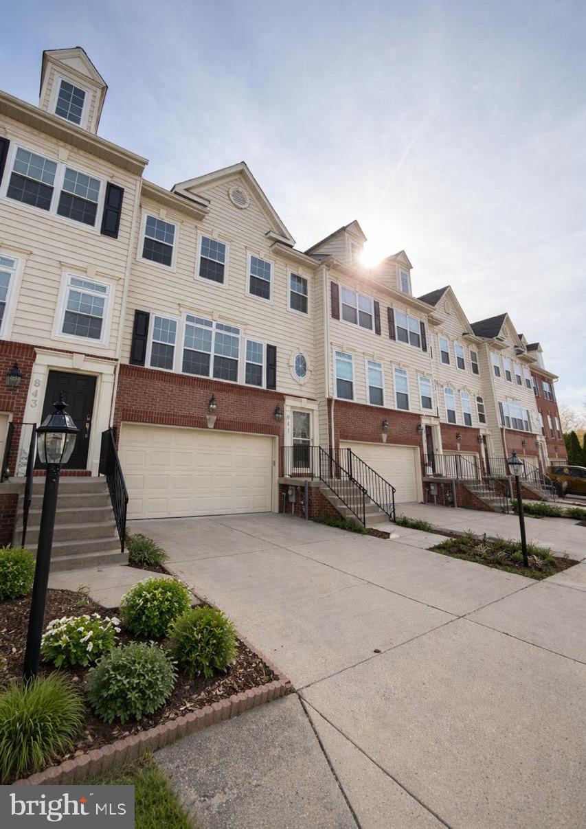 Welcome to the sought-after Tanyard Springs community. This well-maintained 3-bedroom, 2 full / 2 half bath townhome offers over 2,575 finished square feet across three levels! The house is move-in ready and  loaded with upgrades rarely found in comparable homes.

The main level features gleaming hardwood floors and an open-concept living and dining area anchored by a gas fireplace with mantel. The granite kitchen is designed for both function and style, with a center island, gas range, stainless steel appliances, pantry closet, and direct access to a spacious composite deck overlooking a peaceful, tree-lined backdrop. A main-level powder room adds everyday convenience.

Upstairs, the vaulted primary suite offers two large walk-in closets and a spa-style en-suite bath with soaking tub, separate walk-in shower, and dual vanity. Two additional bedrooms with ample closet space, a full hall bath, and convenient upper-level laundry complete the level.

The finished walk-out lower level is a true standout: a very large flex space ideal as a private guest retreat, home office, gym, media room, or future fourth bedroom setup, with its own private entrance from the two-car garage, a half bath, and sliding doors to a private patio.

Here is where 841 Oriole pulls ahead: the infrastructure is already done. Enjoy an Alexa-enabled smart-home system, EV charging station in the garage, wired sound system, whole-house surge protector, reverse-osmosis water filtration, and high-speed internet wiring supporting up to 5GB service, ideal for remote work. New 2022 roof with a transferable 50-year warranty. Home warranty through December 27, 2027.

Enjoy all that Tanyard Springs offers across 110+ acres of common area, including a community pool with toddler pool, 24-hour fitness center, two tennis courts, half basketball court, four playgrounds, ball field, three dog parks, two pavilions, walking trails, and a community garden with 32 rentable plots, all for a low $94/month HOA. A community walking path connects to the elementary school and park.

Ideally located with easy access to MD-100, I-695, and I-97, and convenient to Fort Meade, NSA, U.S. Cyber Command, Curtis Bay Coast Guard Station, and the U.S. Naval Academy. Centrally located between Baltimore, Annapolis, and Washington, D.C.

Schedule your showing. This is the home buyers stop scrolling for.