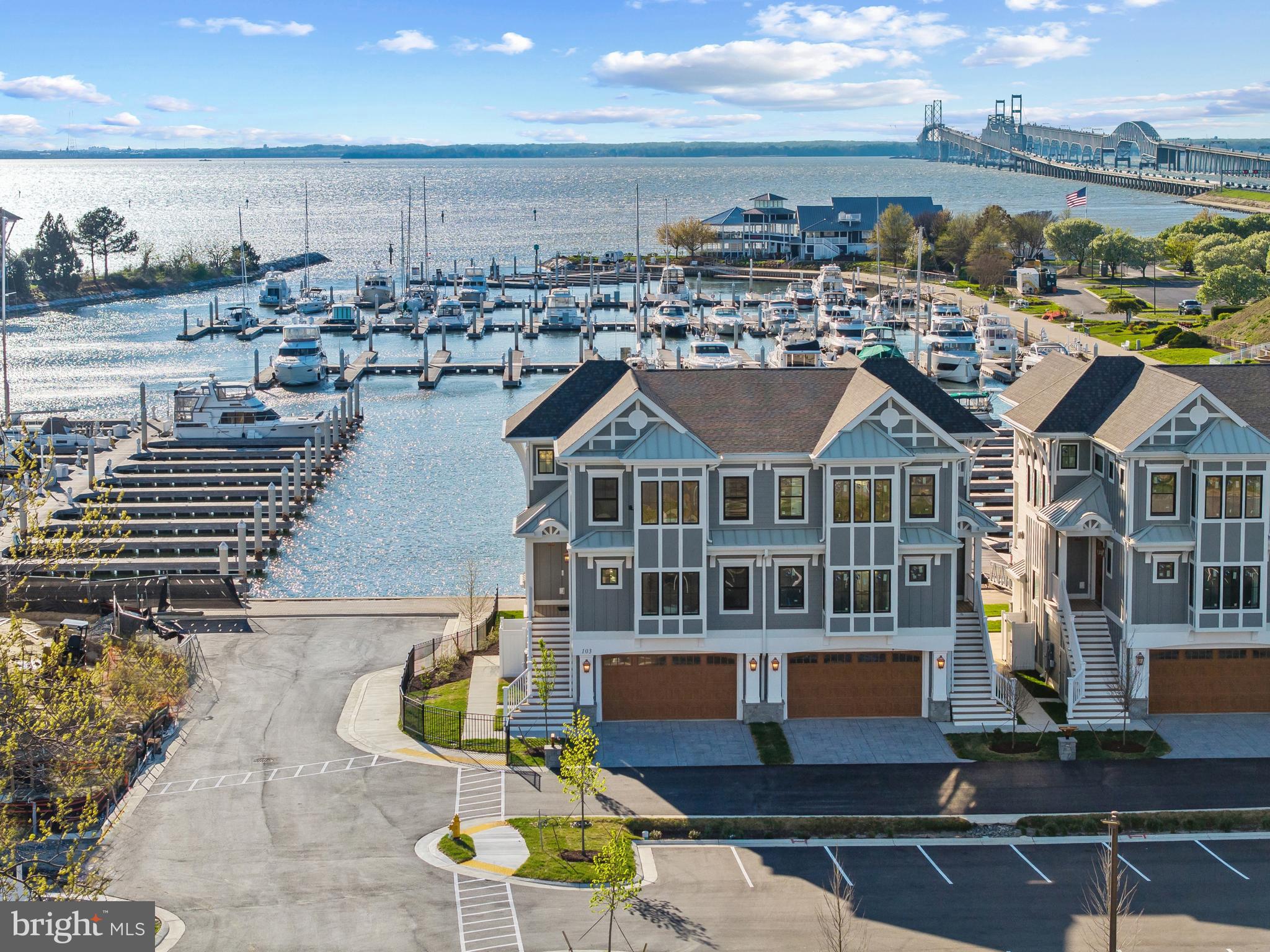 Welcome to Sunset Wharf, a refined waterfront enclave set within the picturesque Bay Bridge Marina, where coastal living is defined by sweeping views and effortless sophistication. This fully completed residence is one of just a select offering within the initial collection of three buildings, each thoughtfully designed with only two residences each, creating an intimate and private setting along the water’s edge.

Inside, the home unfolds across three levels with a thoughtfully designed four bedroom, four bath layout that offers both flexibility and comfort. A private bedroom and full bath on the entry level provide the perfect space for guests or a quiet home office. The main living level is designed for seamless everyday living and entertaining, highlighted by a warm and inviting living room with a gas fireplace that adds both comfort and ambiance. The upper level features two additional bedroom suites, including a serene primary retreat complete with its own gas fireplace. An elegant touch that enhances the sense of relaxation and retreat.

Expansive windows frame captivating views over the marina and out to the Chesapeake Bay, filling the home with natural light and creating an ever-changing backdrop of boating activity and open water. As the day winds down, the setting truly comes to life with breathtaking sunsets that paint the sky and reflect across the water. An experience to be enjoyed from both the interior living spaces and outdoor areas.

High-end finishes and a modern, open-concept design elevate the interiors, while the beautifully appointed gourmet kitchen and well designed baths enhance both form and function. Every detail has been curated to deliver a low-maintenance, lock-and-go lifestyle without compromising on luxury.

Ideally positioned within walking distance to waterfront dining, including Libbey’s Coastal Kitchen & Cocktails and Knoxie’s Table, residents also enjoy immediate access to marina amenities, scenic walking paths, and the relaxed rhythm of life on the Bay. Sunset Wharf offers a rare opportunity to own a newly completed residence in a thoughtfully designed waterfront community where every day feels like a getaway. Welcome Home!