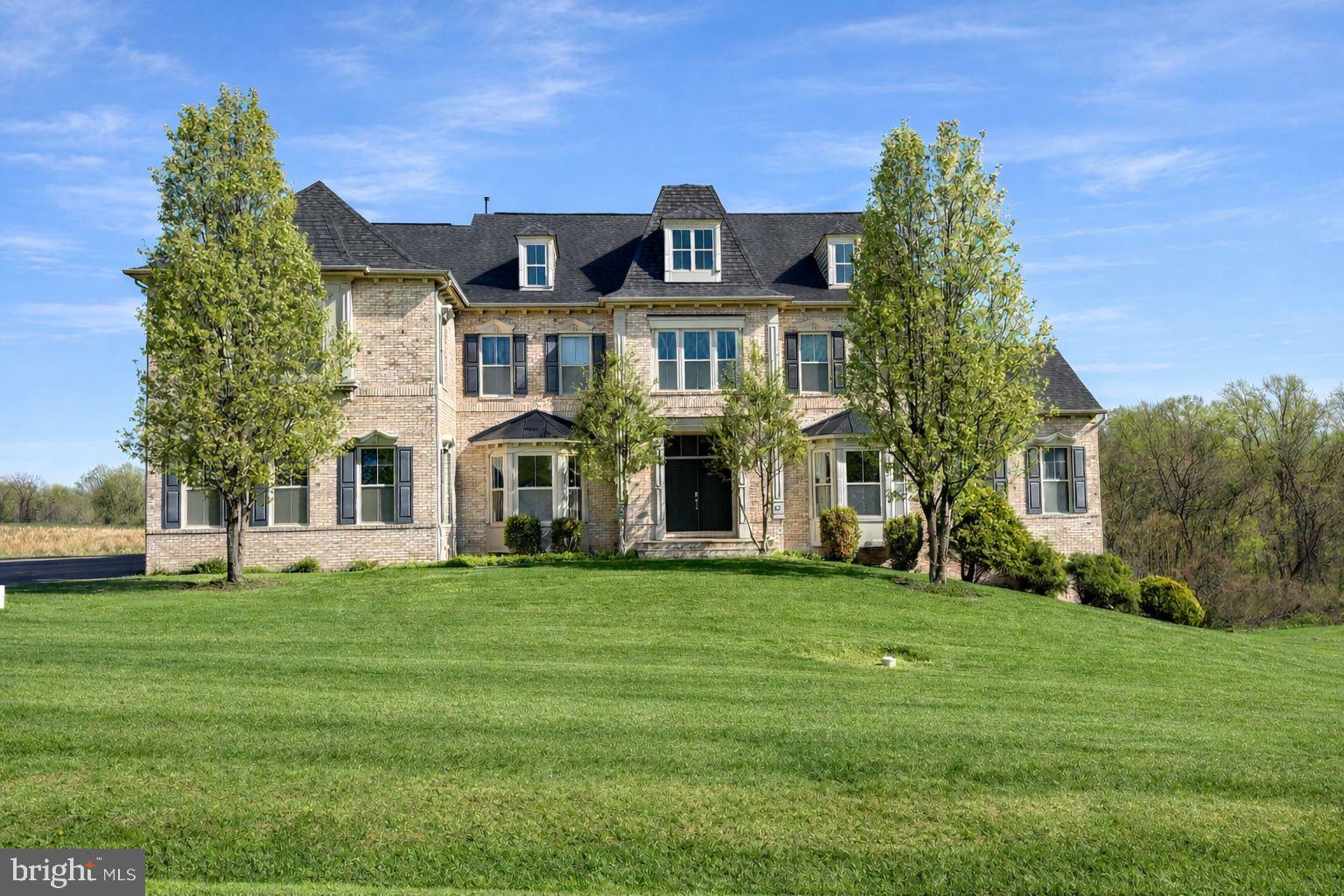 Welcome to 9010 Damascus Hills Lane — a stately brick-front Craftsman colonial offering the perfect blend of luxury, functionality, and privacy.

 Nestled on 3.63 beautifully maintained acres backing to mature trees, this exceptional residence provides a peaceful retreat while remaining conveniently close to everything Damascus has to offer.

Inside, you'll find custom wood flooring, generously sized rooms, and an open, flowing floor plan designed for both comfortable everyday living and effortless entertaining. Natural light fills every level, highlighting the inviting sunroom, bright morning room, and thoughtfully designed gathering spaces throughout the home.

Offering 6 bedrooms and 7.5 bathrooms, this expansive residence provides remarkable flexibility for today's lifestyle, whether accommodating/entertaining guests or working from home. Upper  Level Features include five spacious bedrooms, an impressive owner's suite, and five full bathrooms, providing plenty of comfort and convenience.

The fully finished walk-out level basement spans the entire footprint of the home and features abundant natural light from oversized windows, a private bedroom and two full bathrooms, a large kitchenette/bar area, dedicated gym space, and expansive recreation area.

Rarely does a property combine this level of space, privacy, and versatility in such a desirable setting. Whether you're seeking room to grow, entertain, or simply enjoy the tranquility of estate living, 9010 Damascus Hills Lane delivers.
A distinguished home. An exceptional opportunity. Ready for its next chapter.