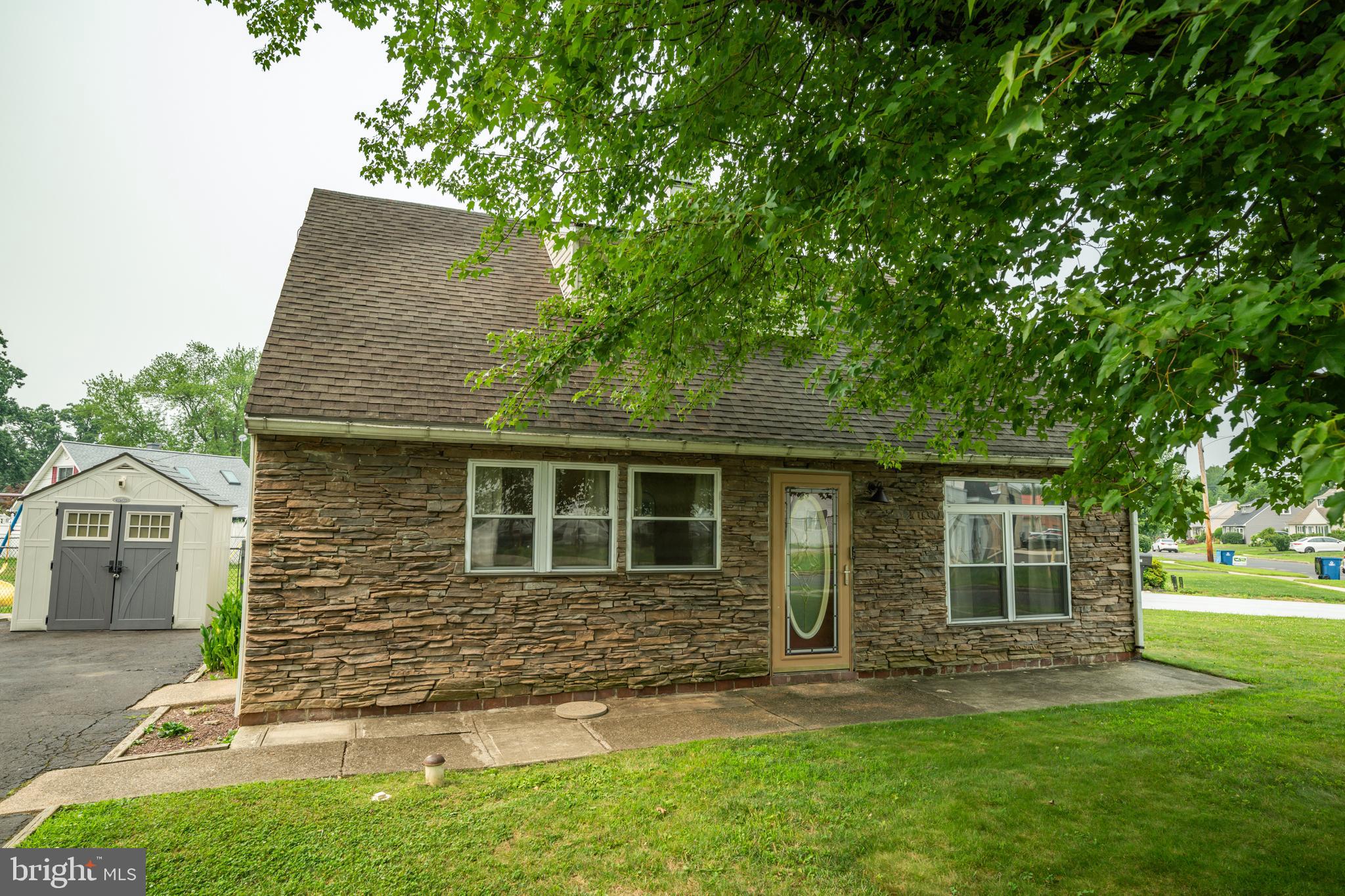 Move-in ready and fully updated, this charming 3-bedroom, 2-bathroom Cape Cod in Morrisville proudly commands a premier 8,800 sq ft corner lot. This highly desirable corner positioning provides exceptional curb appeal, abundant natural light, and rare neighborhood visibility. Alongside the ample street parking afforded by the corner location, a spacious three-car driveway offers dedicated, off-street convenience for homeowners and guests alike. While the current 1,248 sq ft layout offers an incredibly efficient, low-maintenance footprint, the massive outdoor parcel opens endless possibilities for grand-scale entertainment, gardening, or future expansions. Inside, thoughtful design choices maximize every inch of space, featuring elegant wall sconces that provide brilliant illumination while eliminating cluttered table lamps. The versatile interior features incredible flexibility: the current laundry room boasts its own private exterior exit and can easily convert into a fourth bedroom. Because the plumbing is already in place, transitioning the laundry utilities into a space-saving stackable configuration in the mudroom allows this new room to feature its own private bathroom, creating a true primary suite or income-producing rental unit. Every major component of this turnkey home has been completely updated within the last 10 years for total peace of mind, including a fully renovated kitchen, two modern bathrooms, a newer furnace, a newer water heater, updated plumbing pipes, vinyl flooring, light fixtures, and a full suite of appliances. Equipped with central cooling and a whole-house backup generator, this home offers absolute worry-free living. Commuters will love the unparalleled regional connectivity with effortless, immediate access to Route 1, I-295, Route 13, and the PA Turnpike. Best of all, enjoy a highly walkable neighborhood lifestyle just a short stroll from local shopping centers, fitness routines at Planet Fitness, and weekend entertainment at Morrisville Lanes. Don't miss your opportunity to see this beautiful home today!