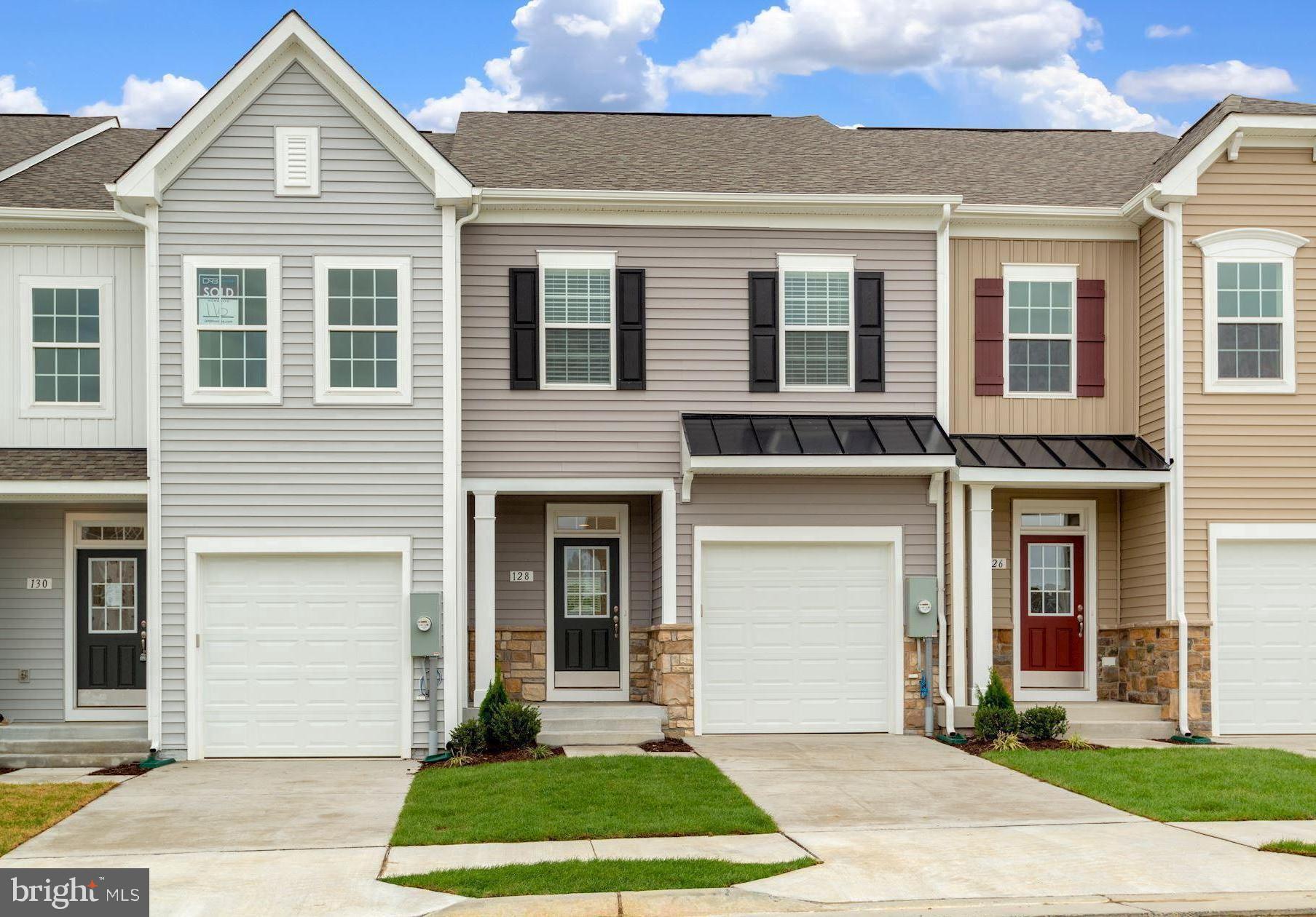 Beautifully appointed garage townhome located in Freedom Manor. Built in 2022 this home features close to 2400 finished square feet on 3 levels and is ideally located on one of the best lots in the neighborhood! No more hauling groceries up the stairs as this floor plan offers that highly desirable main level entry making this the perfect home for easy living. Just a few of the interior upgrades include warm luxury vinyl plank flooring spanning the main level and upstairs landing. Oak stairs connecting the levels for that clean, modern look. In the kitchen you will be pleased to see that no expense was spared! Upgrades to the space include soft close cabinets with contemporary hardware, complimentary backsplash, under cabinet lighting, premium stainless appliances, apron sink and quartz counters. Please note this home features the upgraded alternate main level floor plan that shifted the kitchen location and added more cabinetry and counter top space. Head upstairs and envision waking up every morning to that peaceful tree lined view from your owners suite complete with tray ceiling, siting area and spacious closet. Owners bath features shower with large scale tile and frameless glass door, quartz counters and upgraded fixtures. Two additional oversized guest beds with cathedral ceilings, shared bath and laundry room finish off the upper level. Downstairs is your finished walk out basement with full sized windows, full bath and more room to relax or use as a fourth bedroom. Out back you will find a large composite deck creating the perfect setting to fire up the grill and enjoy entertaining family and friends. Plenty of visitor parking and close to shopping, dining and commuter routes. This home checks all the boxes, schedule your showing today!