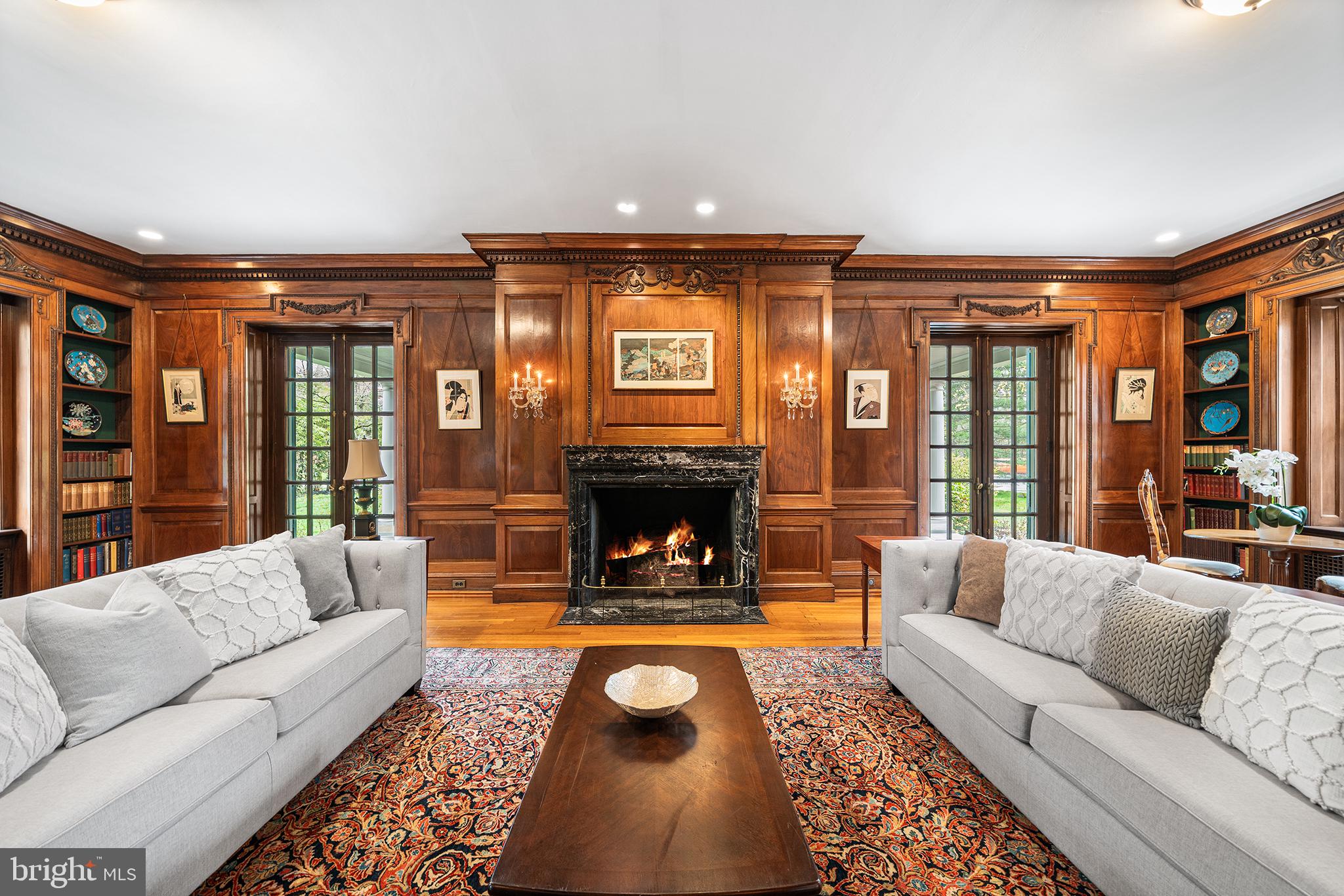 6600 Wissachickon Avenue in the West Mount Airy neighborhood of Philadelphia is a once in a lifetime opportunity to own a home designed by famed gilded age architect, Horace Trumbauer for textile magnate, Joseph Wasserman. The Trumbauer-Wasserman house (1909) is one of the few remaining homes with preserved original details in this country designed by Trumbauer, who is best known for his design of the Philadelphia Art Museum. This truly special home is situated on just under 1.3 acres of land, located steps from Wissahickon Valley Park and offers over 8,000 square feet of beautifully crafted living space, including seven bedrooms and five bathrooms plus an on-site freestanding carriage house. This home features a main floor designed by Trumbauer as the ultimate entertainment space with an extraordinary reception room, dining room with “hidden” cabinets in its wooden paneling, two accessible outdoor entertaining spaces, an intimate sitting room, formal living room, and spacious kitchen with a large pantry. Notably, the formal living room features floor-to-ceiling original book-matched English walnut paneling that was handcrafted in London, later shipped to the United States, and delicately reassembled in the home, accented by the original green marble fireplace. There are six original fireplaces inside the home and one outdoor fireplace for the rear patio space. The kitchen has been sensitively modernized with custom cabinetry, including a subway-tile backsplash accented by a handcrafted mosaic tile, seamlessly built-in Sub-Zero refrigerator, checkered marble floors, a stunning Lacanche range, handmade and imported from France, plus an oversized island and a large pantry. The second floor features four bedrooms, including a primary suite with gorgeous original fireplace, a vintage wall safe, two walk-in closets, a fully renovated bathroom with a focus on period-appropriate details and a dressing room with another stunning, original fireplace. A traditional “sleeping porch” is located adjacent to the primary suite. There is also a spacious den on the second floor that could comfortably function as a bedroom space if desired. The third floor features a casual living space, two bedrooms, another full-size bathroom with a refinished clawfoot tub and a stunning built-in wardrobe area. The Wasserman family were in the textile business and this handcrafted wardrobe space was likely an area used to carefully store the family’s personal collection of household textiles. Outside, there is a large carriage house with fully functional one-bedroom apartment space and a four-car garage for your vehicles. The main house is surrounded by the beautiful evolution of a French-inspired garden including multiple outdoor living spaces and two mature Japanese maple trees that thoughtfully define the main entrance to this remarkable home. This home is a truly stunning piece of American history that you likely won’t find again. ***This home is located less than 10 miles away from Center City Philadelphia and the Amtrak to New York City and less than 15 miles from the Philadelphia International Airport for easy travel to any destination. ***