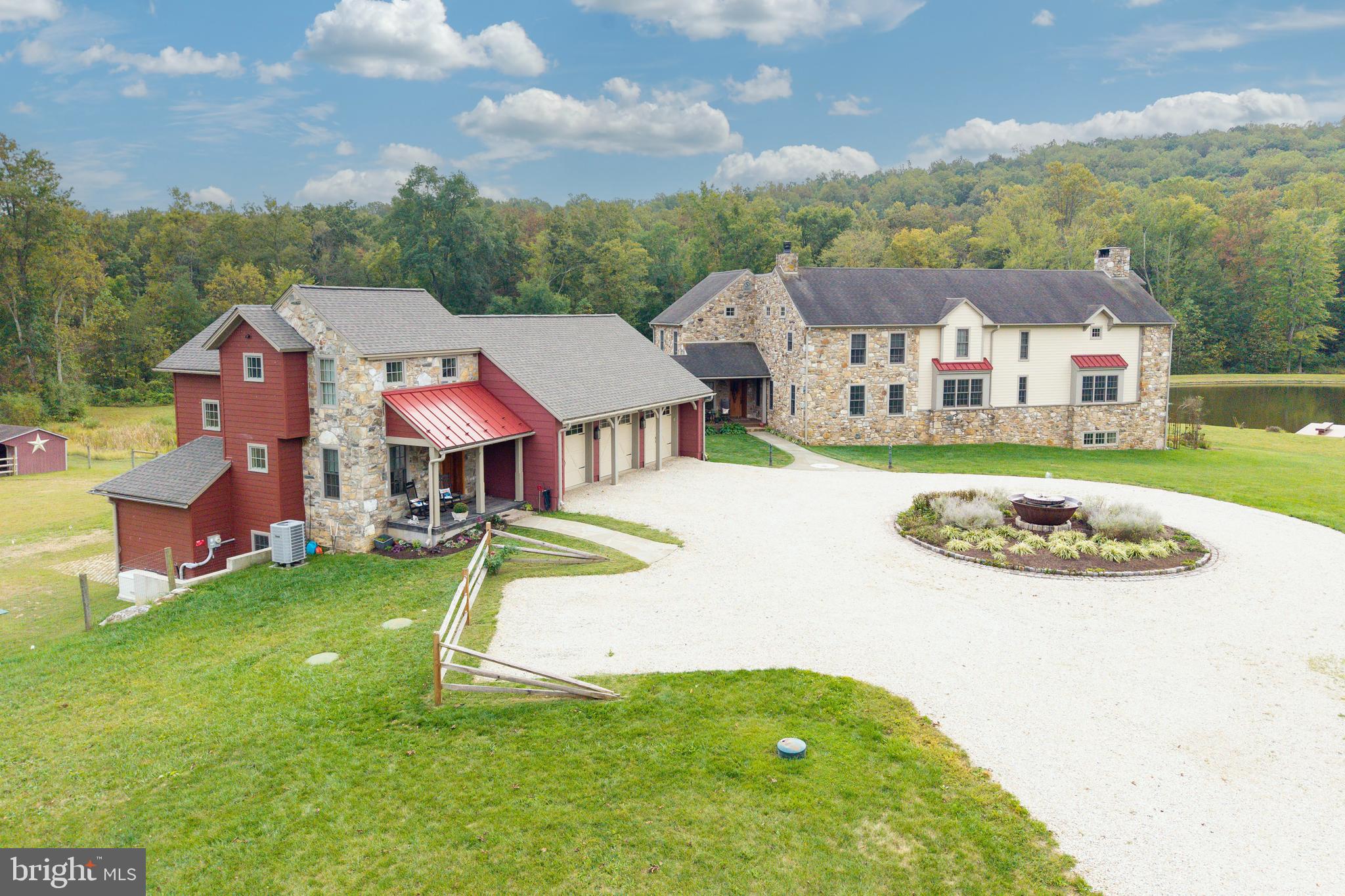 Welcome to Grist Mill Farm- The dream that turned into a reality!! This 7,000 sq ft Masterpiece was built in 2007 and sits on 35 acres of which 25 acres is wooded.  The home was built with historic elegance, modern comfort, luxury and function. Starting out w/ a circular driveway, that features a Cast Iron Sugar Kettle fountain w/ water and elec. with the millstone being from the original grist mill. The cobblestones surrounding the fountain area are from Fairmount Ave in Philadelphia. The covered front porch has a bead board ceiling and covered walkway to the 3 car garage. The home is made of Hardieboard and Pennsylvania fieldstone from the previous grist mill est. 1820’s.  Enter thru the Mahogany front door you find the foyer which has 16x16 cobbled Travertine tile, a mudroom w/ dog shower,  cabinets and an O/E.  There is also a powder room w/ 16x16 cobbled Travertine tile, Kohler toilet and Sink.  The elegant Study w/ 18 lite French Dbl Doors, Kahrs engineered hardwood floor, crown moulding, chair rail, built-in book shelves, mahogany window sills, cigar fan and a cozy propane fireplace w/ granite hearth. The main rooms have 5” Kahrs engineered hdwd floors.  You can relax in the Hearth room w/ a Propane fireplace w/ granite surround.  The well appointed Chef’s Kitchen is adjacent and has a 50”x 108” Granite island, numerous cabinets in custom mahogany island, 4 corner electric, Warming tray and a 18” sink.  The Upgraded Viking line appl. are Microwave, Electric Wall oven, 48” stove has 6 burners w/ griddle and 2 Ovens (1 French).  There is also a Bosch D/W, a porcelain farm sink, 4 inch back splash with all pull out drawers that retreat, Impressive 42” Custom Cabinets and a 48” 2 piece Thermador Fridge and Freezer. The Dining Room has Lighted glass cabinets and a wine fridge. The Butler’s pantry has 2 sides of cabinets and a leather granite top. The 2 story Family Room, complete with stone walls, and all stone Rumford fireplace from Floor to Ceiling with a handmade brick surround, known for being highly efficient with a tall and shallow firebox which allows heat to reflect into the room. You have 2 entrances to the 602 sq ft NEW Premium Trex deck w/ 2 ceiling fans.  In the back of the property you will marvel at the 1.75 acre pond w/ 4 aerators and is stocked w/ fish. On the 2nd floor, The Majestic Mstr. Suite has French doors to a 8’ Deck, Granite surround Gas fireplace, H/H closets from Closets by Design and a Juliet Balcony overlooking the FR. The Sumptuous MBA has a Bain Ultra jacuzzi w/ small jets and a heated back rest, His/Her porcelain sinks w/ granite tops, tiled shower w/ frameless glass door, 4 Body jets, 20x20 tile floor and a separate water closet. The 2nd flr has a Laundry room with 2 Addt’l Br’s which feature hdwd floors, access to the attic and a full hall bath w/ 12x12 ceramic tile and Full tiled Shower. The Garden Level leads you to a 4th BR w/ 2 closets, 3rd Full Bath w/ travertine sink top and a large outside patio to enjoy your oasis.  There is a Hobby Rm, Large Rec area, Bar area w/ Lighted glass Cherry cab., wine fridge and copper sink. There is a Lg workshop w/ multiple windows, Heat and A/C and Dbl doors to the Outside. Featured upgrades: All rounded corners, master switch for 1st flr lights On/Off, All switches have dimmers, All windows are 24” deep. Each window has a night light with auto on/off at dusk/dawn. There is a security system and a built-in house stereo. Upgrades also include All lighting, Faucets, Cabinets and Auto. Generators for house and Office, 2025 Well McClain Boiler w/ 11 heating zones, 3 Zone A/C and radiant heating on all 3 floors. The ext. features inc. a 3 car Gar. w/ 3 openers, equip. Shed, run in w/ elec. and water and 6 raised garden beds, The NEW 2 story Office next to Barn is 900 Sq ft, w/ LR, BR, 1 1/2 bath, Kitchen and a Deck overlooking pastures. Located in the Award Winning Downingtown school dist. w/ the STEM Academy!!  Show and Sell!!!