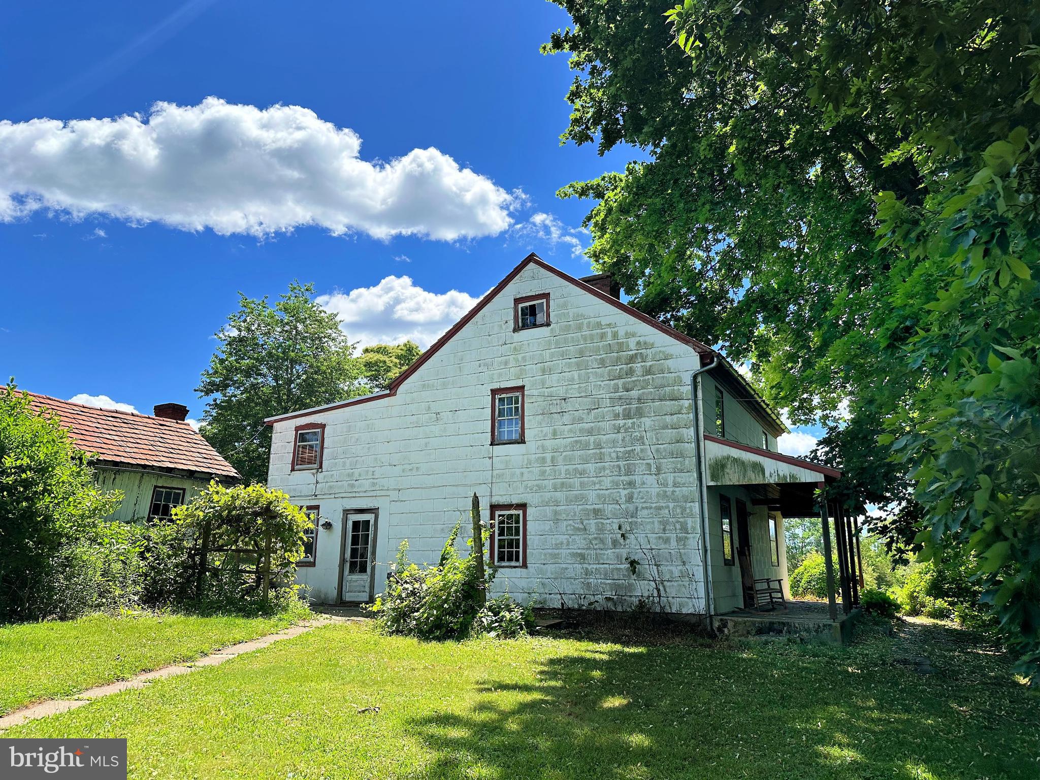 What a find and ready for your restoration!  Original log home dates back to 1759 and the addition was added in the 1800's.  This home has old world charm which includes the open beam ceilings, plank floor and walk-in fireplace.  The first floor offers the kitchen, living room, dining room, den and bonus room which would make a great office.  There are two sets of stairs to access the second floor.  One is in the original section and the other is in the addition.  Both upper levels have multiple rooms and one hall bath.  There is a  walk up attic for plenty of storage.  A new roof was put on the home January of 2025. Plus there is a large bank barn that offers endless possibilities.  The structure is in good condition but will need a roof.  Also you will find multiple outbuildings.   At one time it was an Inn for folks traveling to Kutztown.  Close to main routes of travel and Montgomery County Park system that has many recreational opportunities including horse and walking trails.  This unique property is one that you must see to appreciate.