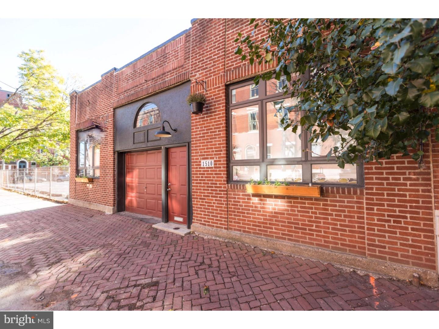 Unicorn spotted in the Fairmount/Art Museum neighborhood! This exquisite 1-story, Loft Style 2 bedrooms, 2.5 baths, with Garage and with a 38' width footprint is a rare find! Once you step into the foyer entrance you are immediately ushered into an enormous open concept floor plan with bamboo flooring throughout, towering overhead original timber beam ceilings and exposed brick throughout. The living area is swoon worthy with both a romantic element of fire with a floating fireplace and skylights that fill this space with natural light. The chef inspired kitchen is jaw-dropping and has so much functionality. We love the quartz counter tops, smartly designed flat panel cabinetry, a beverage/wine center, stainless steel appliances, goose neck faucet, undercount sink, a sexy stainless range hood, peninsula bar seating, and both orb and pendant designer lighting to top it off to complete perfection! The layout is so brilliant with abundant room for a large dining room and living space and countless options for furnishings. A convenient powder room and laundry room are tucked into the hallway. Laundry room includes a front load side by side washer and dryer and a folding center with plenty custom cabinets. The bedrooms in this home will not fail to wow you. Features such as a massive sliding barn door, built in closets, and incredibly modern touches. The 2 custom tiled full baths have features like none other such as wall mounted faucets, artisan porcelain sinks, gorgeous varieties of material from flooring to vanities, and frameless glass shower enclosures. Each room in this home features high-end custom lighting, central air, exposed duct work and offers that NYC style urban industrial appeal with full on in your face luxury upgrades! North Street literally has it all and then some and we'd love you to visit today.