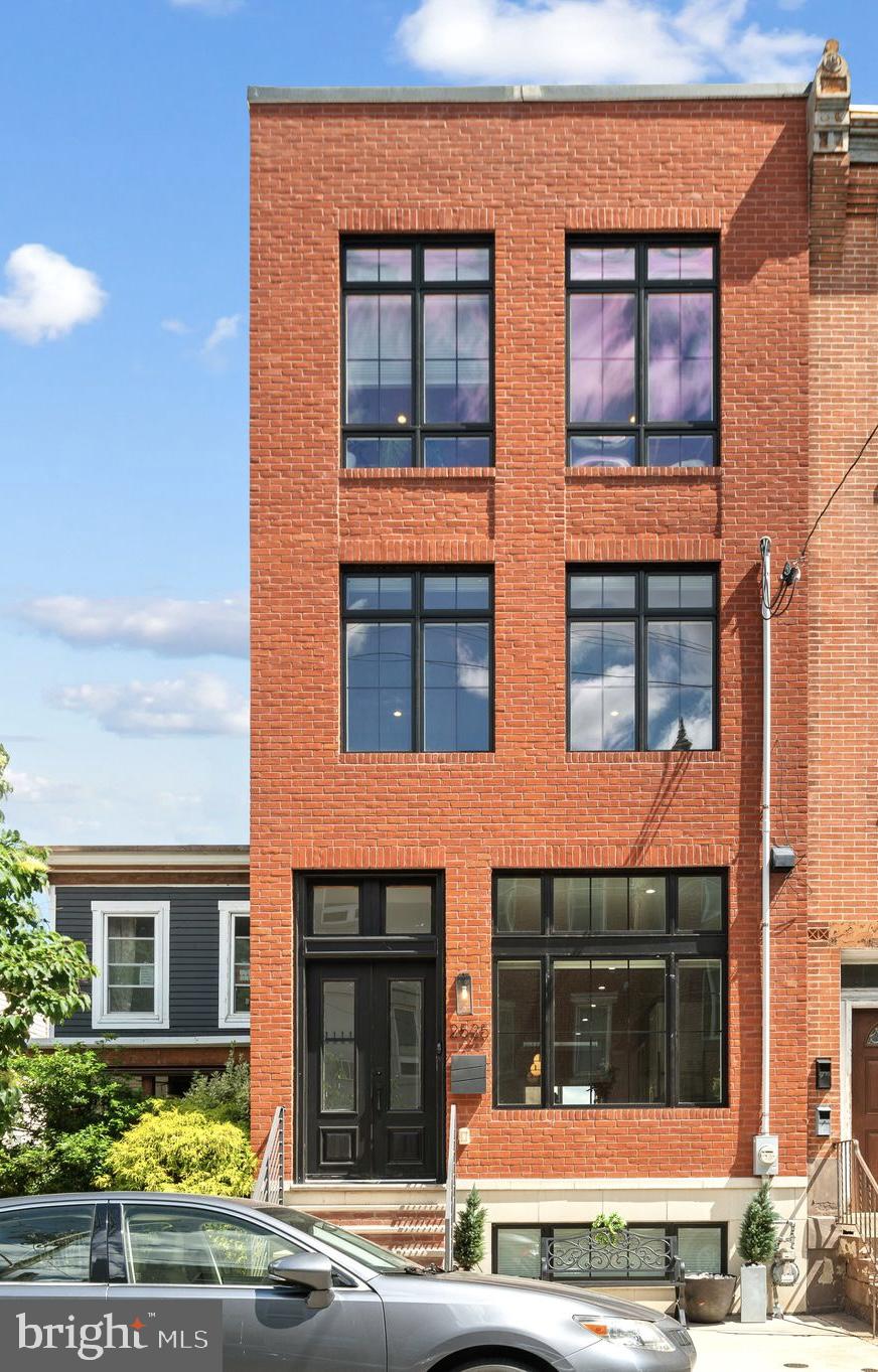 Don't miss this incredible opportunity to own a spacious and light-filled home on one of Fairmount's most desirable blocks. This exceptional residence offers the perfect blend of modern design, generous living space, and outstanding outdoor areas, along with approximately 6 years remaining on the tax abatement! 

Step inside to find hardwood floors throughout, soaring ceilings, and a dramatic two-story living room flooded with natural light. The open-concept main level is ideal for both everyday living and entertaining, featuring a large dining area with oversized front windows, a stunning chef's kitchen with a massive center island, GE Café stainless steel appliances, abundant storage, pantry space, and stylish lighting. A convenient powder room completes this level. Just beyond the dramatic living room, an expansive private yard provides the perfect setting for outdoor dining, entertaining, gardening, or simply relaxing.

The second floor is dedicated entirely to an impressive primary suite. This expansive retreat features two walk-in closets, three oversized windows spanning the home's 18-foot-wide footprint and overlooking beautiful tree-lined Brown Street, and a luxurious en-suite bath with a soaking tub, double vanity, beautiful tilework, and a large walk-in shower.

The third floor offers two generously sized bedrooms with outfitted closets, a large laundry room with additional storage, and access to a private rear deck—an ideal spot for morning coffee or evening relaxation.

At the top, an incredible roof deck delivers breathtaking panoramic views of the Center City skyline, Philadelphia Museum of Art, and surrounding cityscape, serving as a true extension of the living space and the ultimate setting for entertaining or unwinding above the city.

The finished lower level adds tremendous flexibility with a fourth bedroom, full bathroom, and a large living area perfect for guests, a home office, gym, media room, playroom, or additional family room.

Rarely does a home combine this level of size, natural light, outdoor space, and location. With an 18-foot-wide footprint, two exceptional outdoor living areas, dual-zone heating and cooling, approximately 3,000 square feet of living space, and a prime Fairmount location just steps from neighborhood restaurants, coffee shops, Whole Foods, Fairmount Park, Kelly Drive, and Philadelphia's world-class museums and cultural attractions, this is city living at its finest.

Some photos are virtually staged.