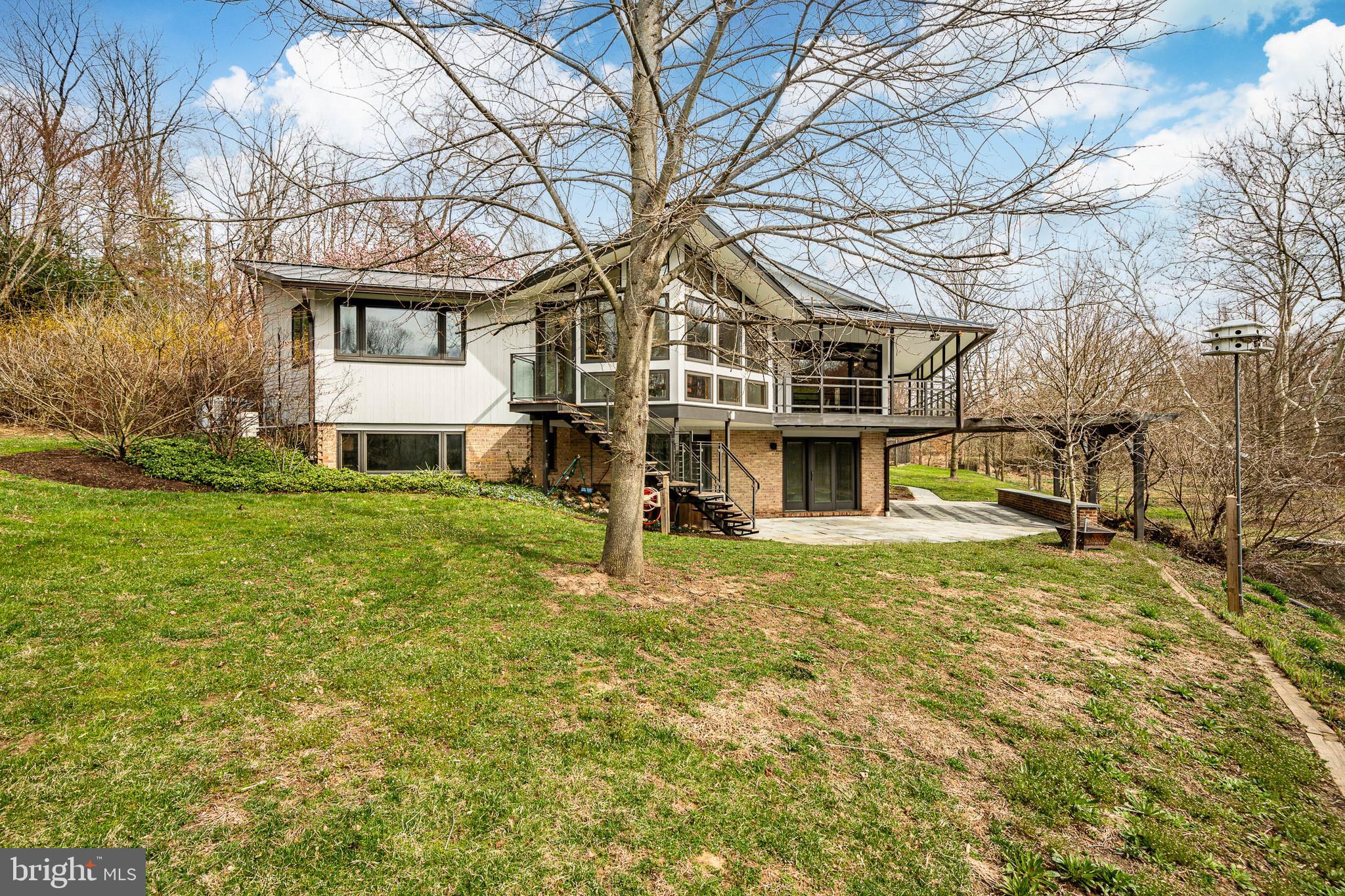 Imagine turning into the driveway and pulling up to your amazing mid-century home that overlooks a gleaming pond that is surrounded by wooded landscape - all that and you’re in Kennett Square, PA of all places! It’s the perfect location to find that dream home that you never thought existed. This home is unique in every possible way from its distinctive architecture to the preserved 10+ acres to the solar array that helps power the major systems. It’s an outdoor-lover’s playground with vegetable & perennial gardens, out buildings and lots of space to explore. Inside you’ll find the ideal single-floor living arrangement with plenty of space to spread out and enjoy all that this property has to offer. Some of the more notable features of this home are the bluestone walkways/patio, the whole house generator, maple cabinetry and induction cooktop in the Kitchen, custom Sunroom addition that is accessible from the Kitchen, Owner’s Suite and the Deck, Ipe wood treads on the stairs to grade, 2 fireplaces, brick accent walls and so much more!  Be sure to review the pre-listing inspections that were completed. This is the type of home that you won’t want to miss out on seeing!