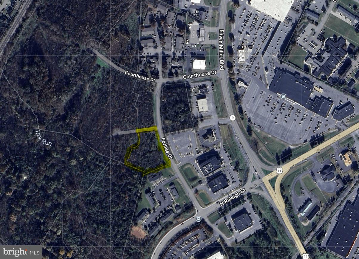 Looking for a  commercial opportunity in the fast-growing, high-density, north end of Martinsburg, but can't stomach the prices of the other options? This 1.8 acre property (Tract A), zoned Mixed-Use Commercial (MUC), offers the possibility to get into this space for around half the price of many of the other currently available options. Permitted uses include general retail, convenience stores, food & beverage, group residential housing, hotels, government facilities, multi-family dwellings, schools, AND MANY OTHERS - see View Docs for the Zoning Ordinance. This property fronts over 300' on Forbes Dr (paved) and backs DIRECTLY up to DRB Homes' 170+/- townhome community known as The Villages at Courthouse Square. Access to this property from Edwin MIller Boulevard would be via the Edwin Miller Blvd and Raleigh St extension intersection (which already has a stoplight) or the Edwin Miller Blvd and Courthouse Dr intersection (which is soon getting a stoplight). An adjacent tract (1.3 Acre Tract B), which also fronts 300'+ on Forbes Dr, and also backs DIRECTLY up to DRB Homes' townhome community, is also available for purchase for $350,000.