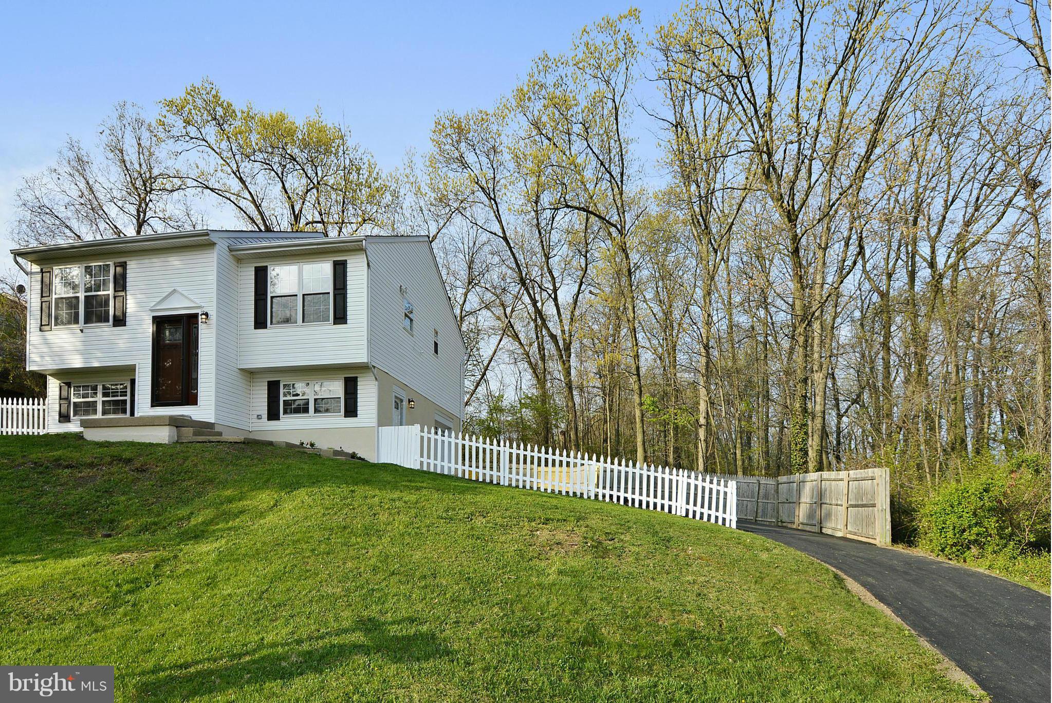 Beautifully updated 4 br 2+bth on .32 acres! NEW - Carrier HVAC, Led fxt, s/s appl, architectural roof, 5" plank hardwoods, carpet, tile baths w/rubbed bronze, slow close cabinets, granite counters, custom entry door, large garage, tons of prkg w/2 driveways, new paving. L/L br with separate entrance.Tax rec 1044 sq ft, actual floor plan 1650 sq ft. Backs to woods, priv fence. Closing help avail.