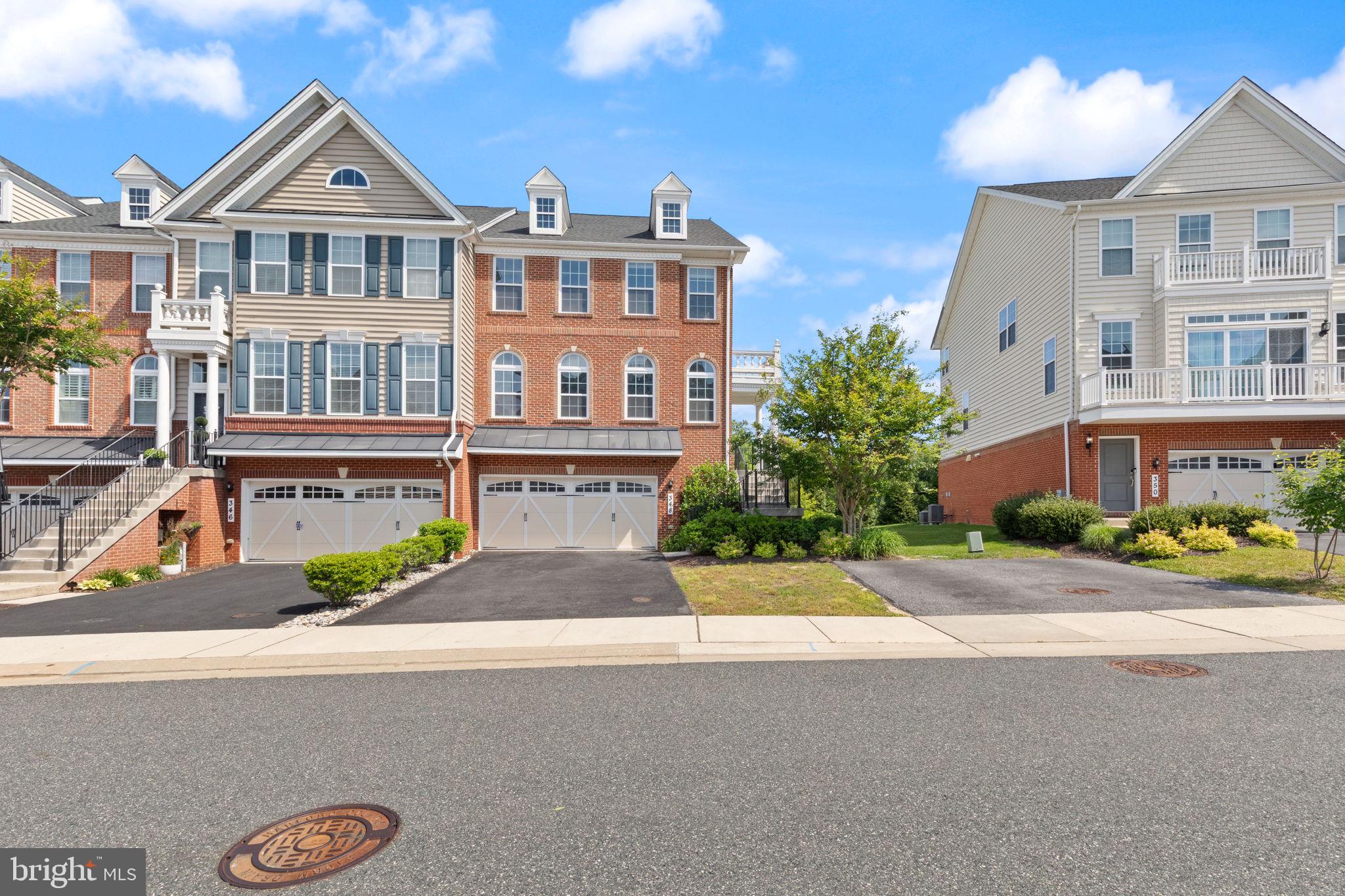 Welcome to Laurel Ridge and this exceptional Toll Brothers townhome loaded with premium upgrades, thoughtful custom features, and a highly desirable premium lot backing to beautiful trees and woods. This spacious 3-bedroom, 3 full and 1 half-bathroom home offers 8-foot bump-outs on all three levels, creating an open, expansive floor plan filled with natural sunlight throughout.  The heart of the home is the upgraded gourmet kitchen featuring additional custom cabinetry, built-in bookcases, upgraded countertops, a large center island, high-end stainless steel appliances, a microwave/convection oven combination, and a premium refrigerator with a built-in K-Cup coffee maker. The kitchen flows seamlessly into the spacious living area, making it ideal for entertaining and everyday living. The living room includes a mounted TV, a built-in entertainment center, and a surround sound system, all of which come with the home. Three mounted TVs throughout the property are included in the sale. High ceilings in the living and dining areas enhance the home's open and airy feel, while beautiful hardwood flooring extends throughout, and all carpeting has been recently replaced with brand-new carpet. The upper level features three generously sized bedrooms, two full bathrooms, and an upstairs laundry area with a washer and dryer. The luxurious primary suite offers two walk-in closets and a spa-inspired en-suite bath complete with a walk-in shower, soaking tub, dual vanities with granite countertops, and tile flooring. The finished lower level includes a full bathroom and a sliding glass door providing easy access to the rear yard. Additional features include an owned alarm system, Ring security system, extra electrical outlets throughout the home, and abundant storage space. The oversized 2-car garage offers additional storage, shelving, and an extra freezer that comes with the property. Outside, enjoy a premium homesite overlooking mature woods, a nearby playground, and the convenience of an additional parking pad located beside the home. This beautifully upgraded Toll Brothers home combines luxury, comfort, functionality, and an outstanding Laurel Ridge location—truly a must-see property!