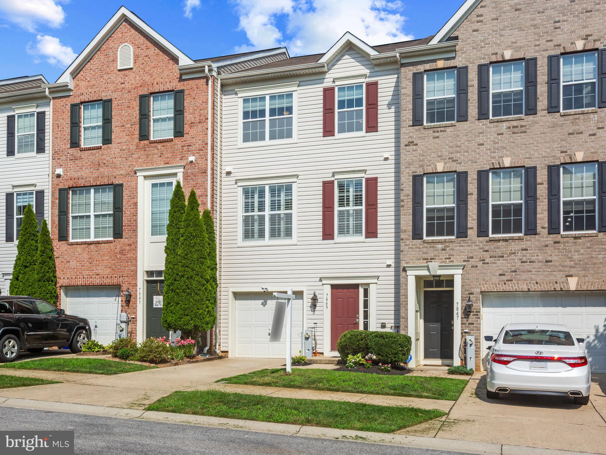 Welcome to 7845 River Rock Way, a beautifully maintained, move-in ready townhome in Columbia's sought-after Simpson Mill community. Located in the highly rated Howard County Public School System, this home is zoned for Clemens Crossing Elementary and Atholton High School. Offering over 3,000 finished square feet with bump-outs on all three levels, this home features 3 bedrooms, 2 full baths, 2 half baths, and a spacious, open-concept floor plan designed for both everyday living and entertaining. Recent updates include fresh interior paint, new flooring in the primary bathroom, and professionally steamed carpets. The entry level features a spacious recreation room, half bath, garage access, and walkout to the backyard. Upstairs, the main level showcases 9-foot ceilings, hardwood flooring, a gourmet kitchen with granite countertops, 42-inch cabinetry, stainless steel appliances, a gas range, center island, and a bright sunroom that opens to a maintenance-free deck—perfect for entertaining, grilling, or relaxing outdoors. A beautiful three-sided gas fireplace creates a seamless transition between the kitchen and living area. The upper level offers a spacious primary suite with a walk-in closet and an updated ensuite bath featuring double vanities and a separate tiled shower, along with two additional bedrooms, a full hall bath, and a conveniently located laundry room. Enjoy a low monthly HOA, no CPRA fee, and an unbeatable location just minutes from shopping, dining, parks, commuter routes, and the Robinson Nature Center.