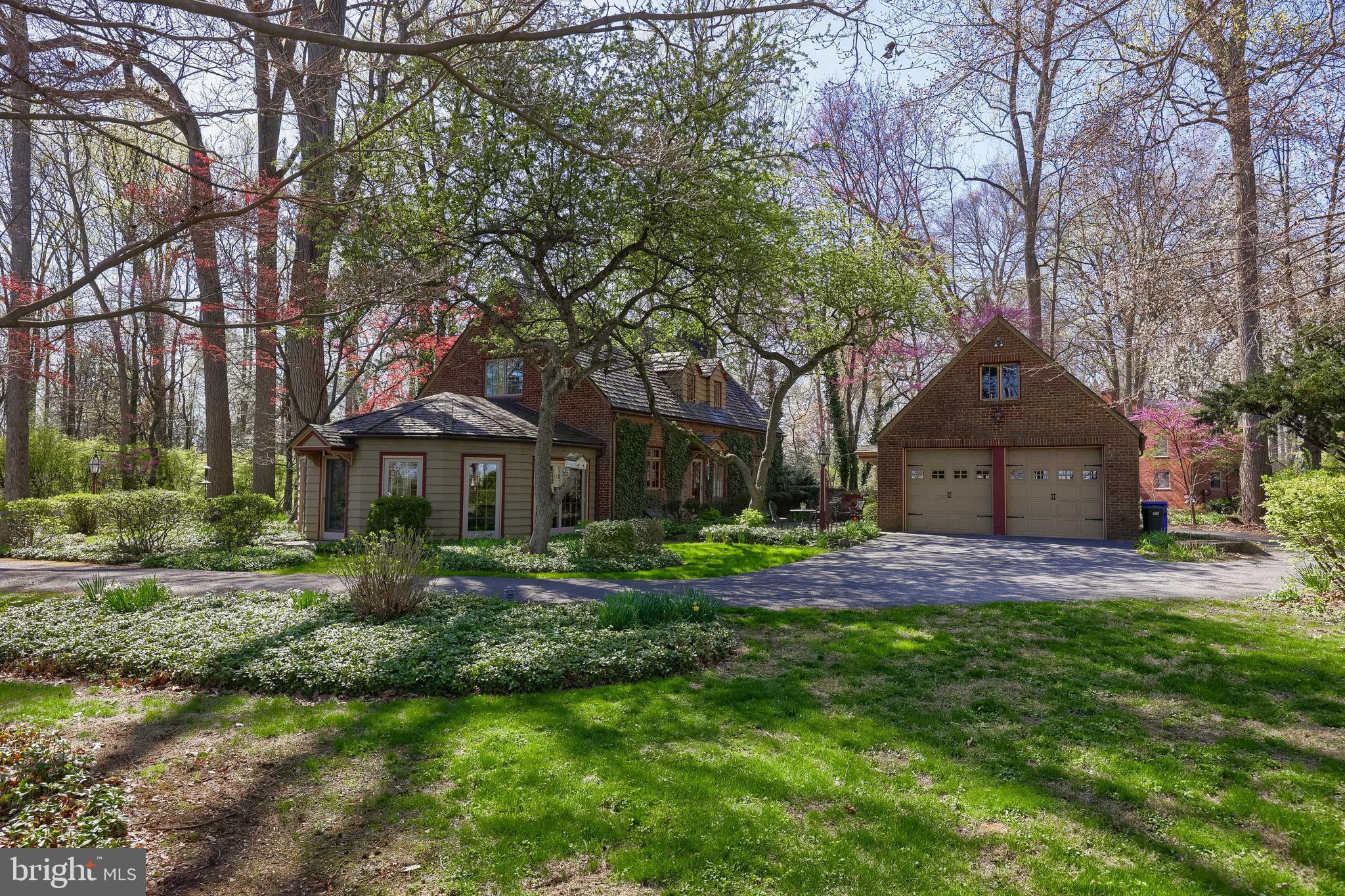 Timeless charm meets modern living! This stunning 4,697 sq ft brick home, masterfully blends classic 1930s craftsmanship with contemporary amenities, all set on a picturesque 4.695-acre property. From the moment you arrive, the circular driveway welcomes you through beautifully landscaped grounds, wrapping around this stately, all-brick exterior home. Inside you will find a spacious layout featuring three bedrooms, two full bathrooms, a powder room, and a bonus room—ideal for a home office or playroom. The main level is a dream with a primary bedroom suite with built in storage and en-suite bath, a formal dining room boasting original hardwood floors and elegant French doors, and a ceramic-tiled kitchen with crown molding that opens up to a sun-drenched sunroom. Vaulted ceilings, brick tile flooring, and sliding glass doors make the sunroom the perfect year-round escape. Downstairs, enjoy a recreation room and a dedicated laundry space, perfect for everyday living and entertaining. Experience the magic of the outdoors—an expansive patio, cozy fire pit nestled in the woods, a fenced garden ready for planting season, and wide-open spaces to roam. This property is a dream for hobbyists, creatives, and animal lovers alike. A detached oversized 2-car garage offers attic storage, a separate workshop stands ready for your next project, and a charming upstairs studio with vaulted ceilings and built-in window seating offers endless possibilities. Horse lovers will appreciate the barn with 3 stalls and over-the-stall storage. This is more than just a home—it's a lifestyle. Whether you’re hosting elegant dinner parties or enjoying peaceful mornings in the sunroom, this extraordinary property delivers space, style, and serenity in equal measure. Don’t miss your chance to own this one-of-a-kind estate!