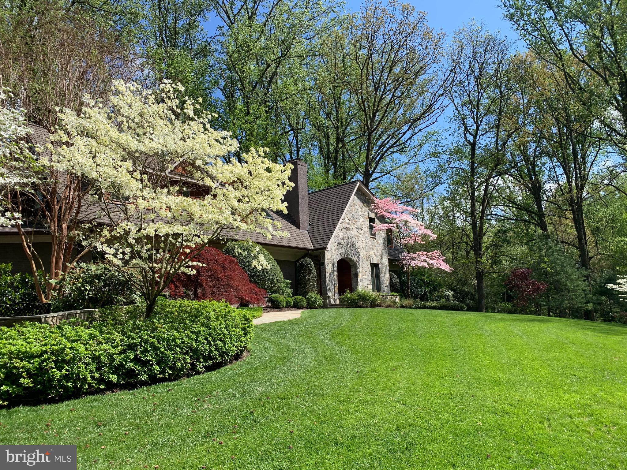 Peaceful Tranquility and Convenience! Wonderful Home on Gorgeous Large Lot just minutes to Downtown McLean. Residence has been thoughtfully planned and added to over the years resulting in a spacious unique and light filled space.  Enter through a Gracious Foyer with a glimpse into the Breathtaking Great Room. Walls of Windows on three sides bring the Amazing Sights of the Rear Yard into this Significant Space.  Stone Masonry Fireplace grounds the room with soaring ceilings and multiple seating spots.  Transition into the Kitchen by way of an Expanded Entertainment Haven with Bespoke Cabinetry, Icemaker, Beverage Fridge and Wine Storage.  Beautiful Wood-Mode Inset Cabinets create the perfect backdrop for a well-planned light filled kitchen with tons of storage including a Pantry and a Large Island bathed in light from a remote controlled Skylight.  The Kitchen is the center of a number of wish list spaces with a Sun Soaked Breakfast Area in one direction,  a Keeping Room in another and a Large Mudroom with Built-ins as you approach the Oversized Garage.  The Formal Dining Room with a Stacked Stone Masonry Fireplace completes this section of the Main Level.  Another Wing off the Foyer features a Main Level En Suite Bedroom and Two Office Spaces.  A Formal Powder Room as well as Large Coat Closet are also located here.  Double Skylights above the Stairway guide you to a Spacious Upper Landing on the Second Level.  The Primary Suite runs the width of the Home on this floor and includes a Large Walk-in Closet with Custom Built In and a Marble Bathroom with Double Vanities and Heated Floors.  Three Additional Bedrooms and Two Bathrooms are also located on the Second Floor.  A dedicated Laundry Room and a Den/ Study  complete this level.  A Huge Lower Level Rec Room is made cozy with a third Masonry Fireplace in the home.  A Powder Room can be found on this level as well as an Unconditioned area perfect for a Work Shop with an outside entrance.  The Exterior of the Home absolutely comes Alive with Mature Landscaping and Plantings which have been accented by well-placed Hardscape and Stone Patio which is easily accessed  from multiple areas on the Main Level.  Perfect for Outdoor Entertaining